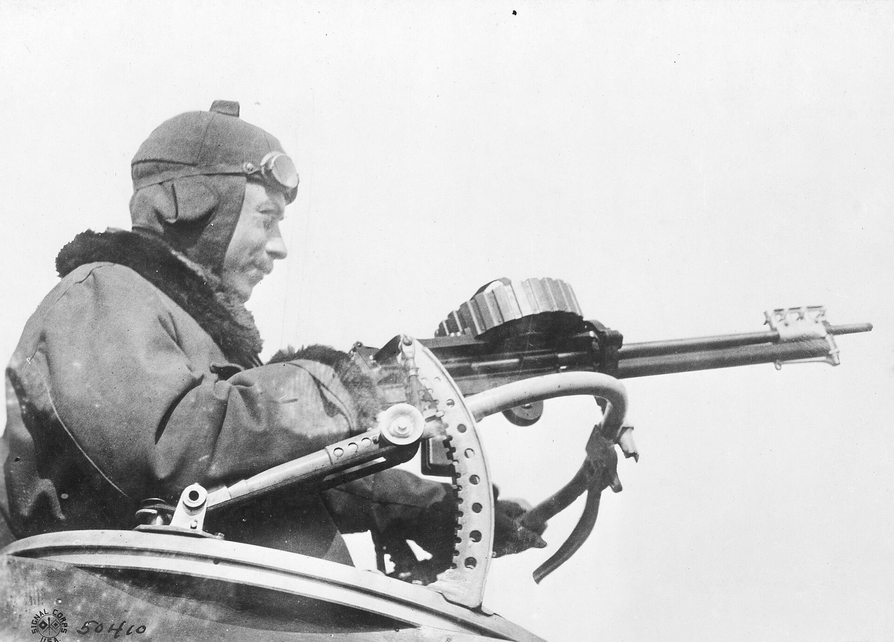 Figure 4 — An aircraft-pattern Lewis gun with a double drum on a ring mounting, in American service. The gun has no radiator, a slim barrel casing and a spade grip. US Army Signal Corps photograph 111-SC-5041…
