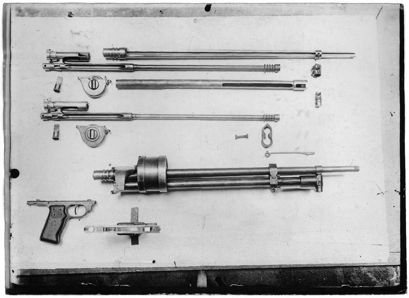 Figure 1 — A French Army aviation workshop's photograph of an aircraft Lewis gun stripped into its groups, September 1917: from the top, the piston rods and bolts, gas cylinders and barrels, the body with its…
