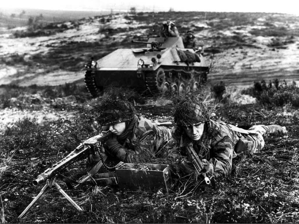 Figure 2 — West German Bundeswehr soldiers in a field exercise in June 1960 with an MG 1 on its bipod, an SPz kurz armoured reconnaissance vehicle behind. The US Army caption names the gun "MG 1". US Army pho…