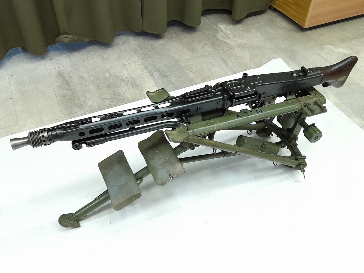 Figure 6 — An MG 42 on its Lafette tripod, with the butt and grip at right, in the collection of Romania's National Heritage Institute; the institute's record gives the gun's calibre as 7.92×57 mm. Photograph…