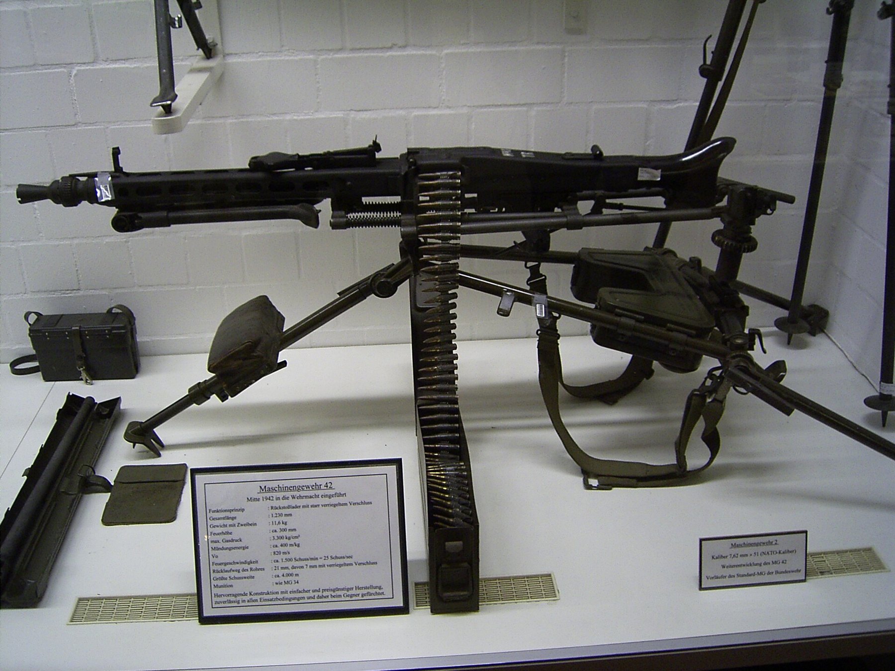Figure 2 — An MG 42 on its Lafette tripod in the Deutsches Panzermuseum, Munster, with a placard that dates the gun's introduction to mid-1942 and gives its length as 1,230 mm and its weight on the bipod as 1…
