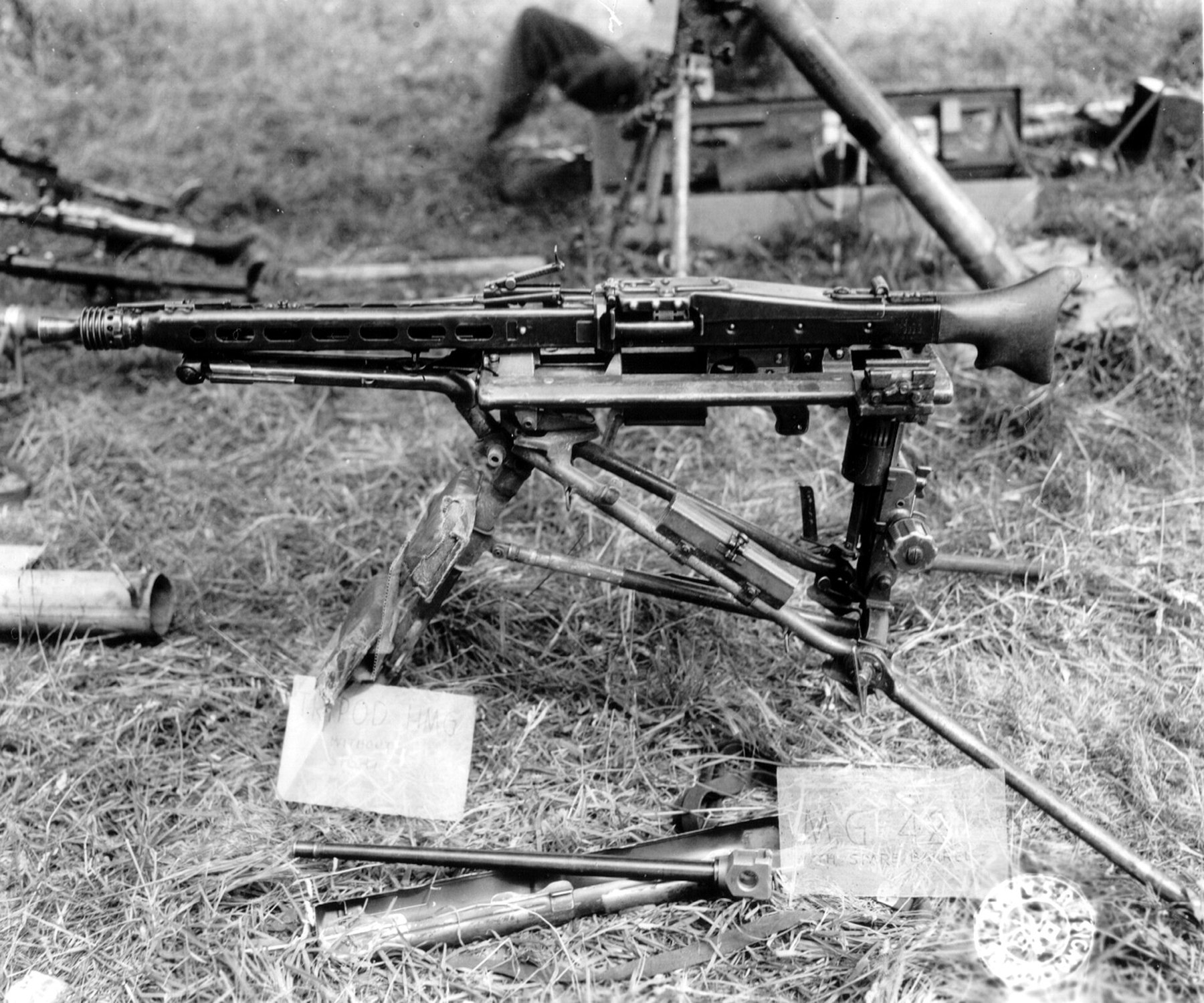 Figure 2 — Captured MG 42s in Normandy, summer 1944, one of them on its tripod, with spare barrels laid out in front. Photograph from the Archives départementales collection "Libération de la Basse-Normandie"…