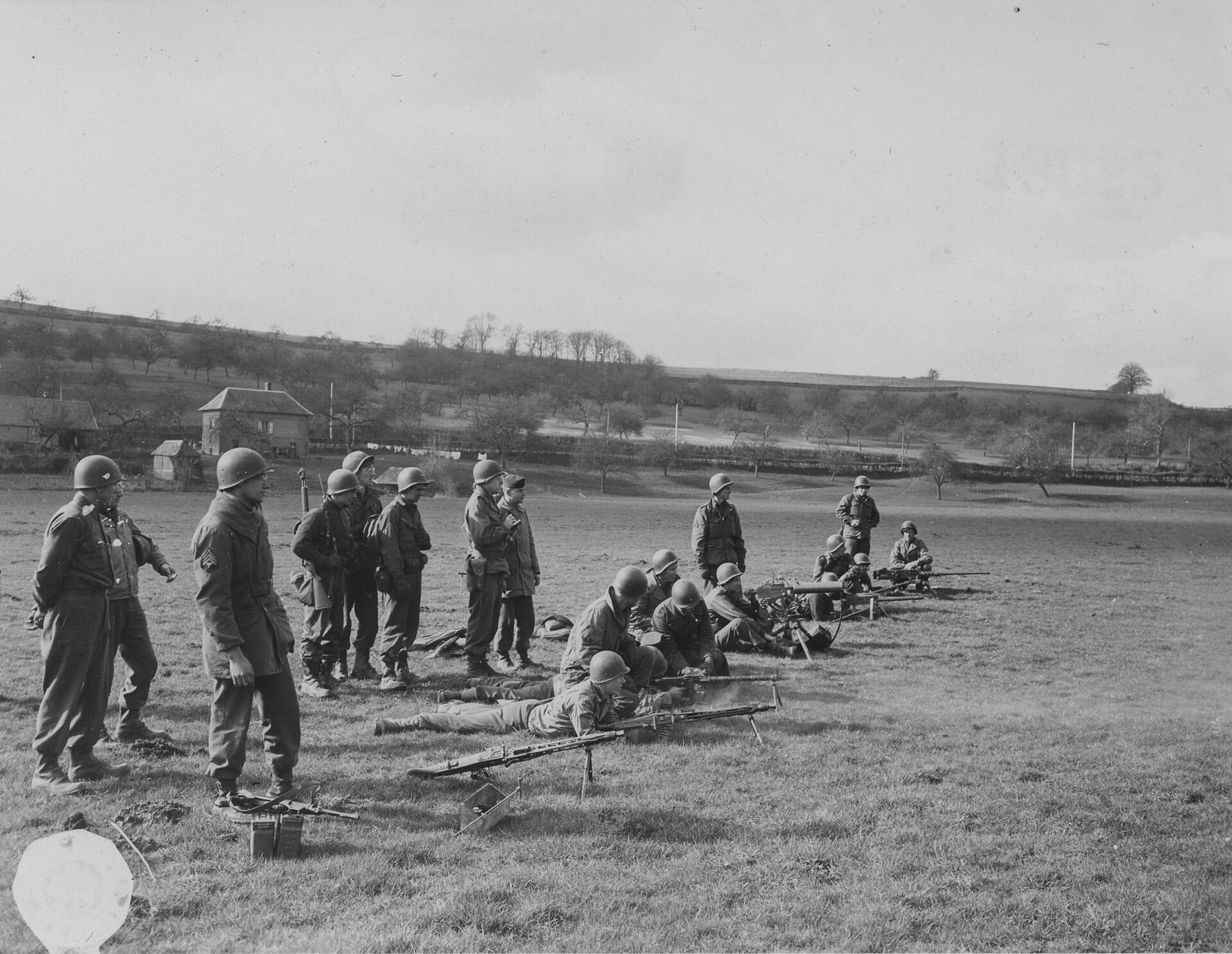 Figure 5 — US troops of a Military Intelligence training unit firing German and American automatic weapons in a line, on 24 February 1945, "to familiarize troops with their characteristic sounds". US Army Sig…