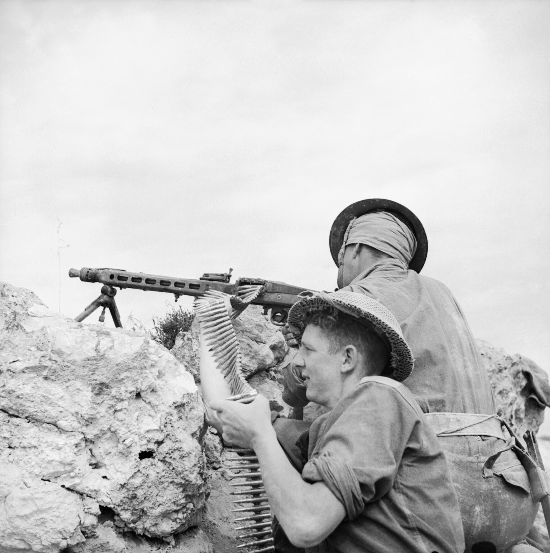 Figure 1 — Men of the 2nd Battalion, Sherwood Foresters, firing a captured MG 42 in Tunisia on 27 April 1943, five weeks after the US War Department's first published description of the gun. The loader is fee…