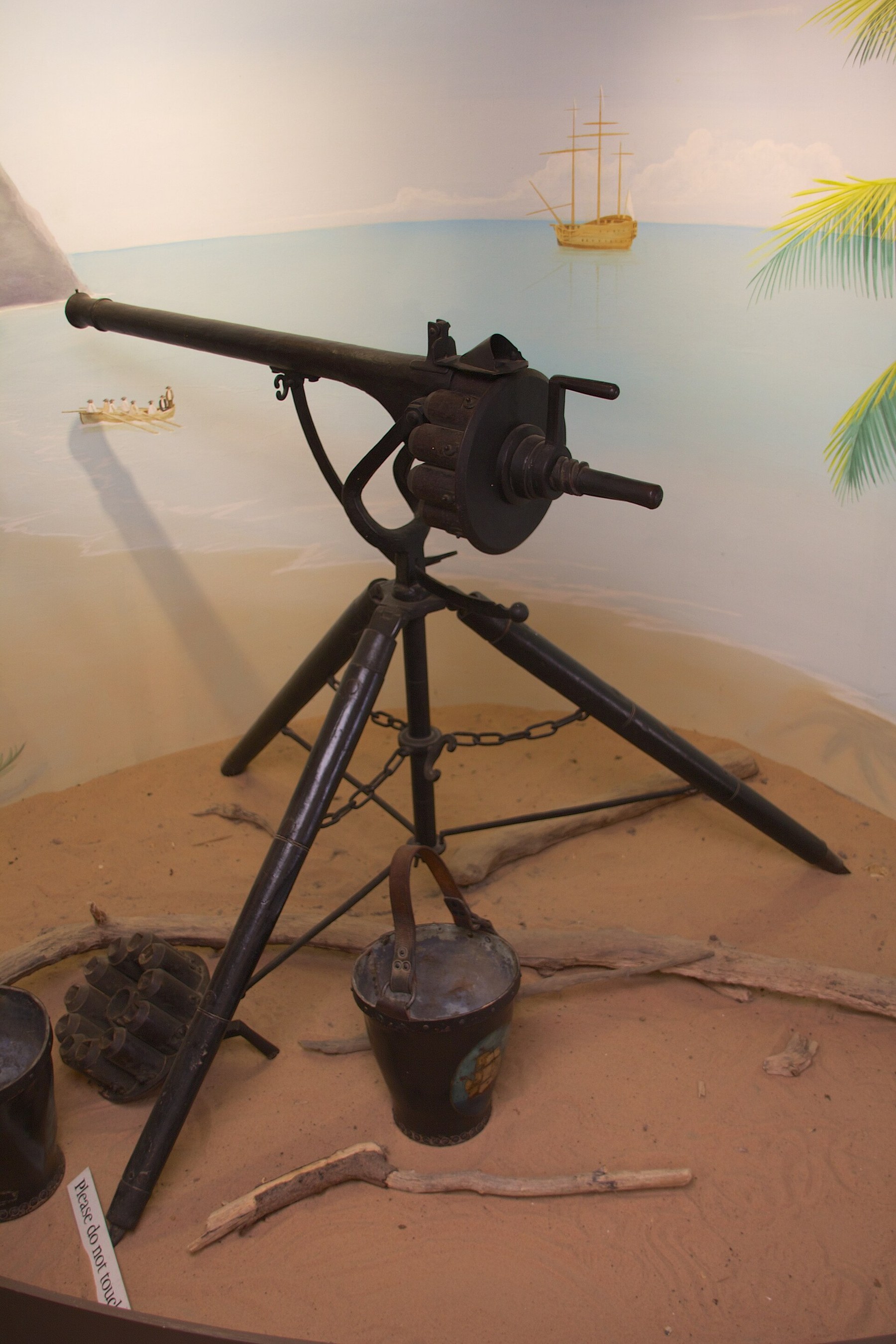 Figure 5 — The same gun from the rear quarter, showing the crank, the lock above the breech and the spare chamber set on the ground. Photograph by Mike Peel (www.mikepeel.net), 2014, Wikimedia Commons, CC BY-…