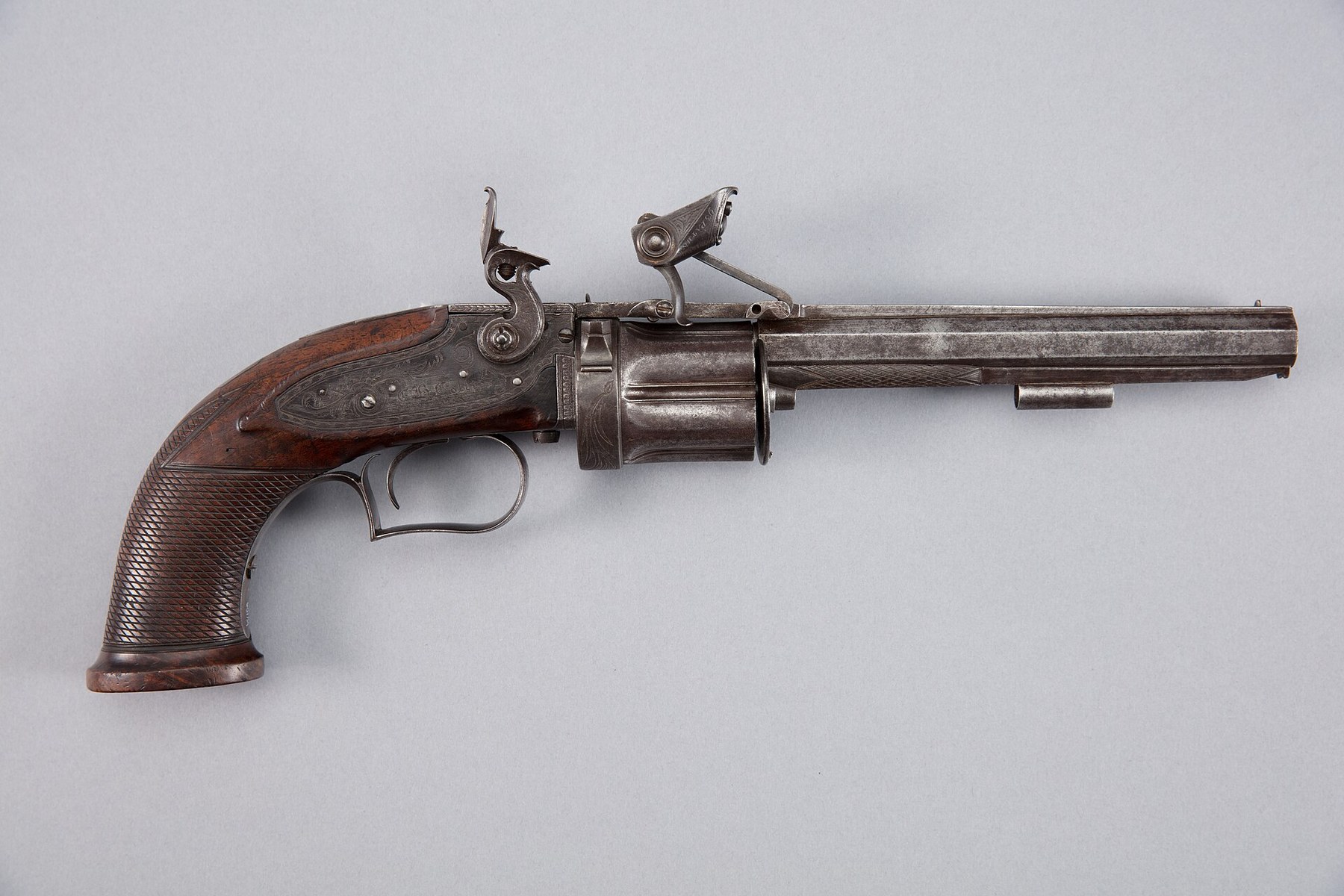 Figure 2 — A Collier flintlock revolver of about 1818 in the Auckland War Memorial Museum. Like the Puckle, it drives its cylinder forward against the barrel to seal the joint; unlike the Puckle, its cylinder…