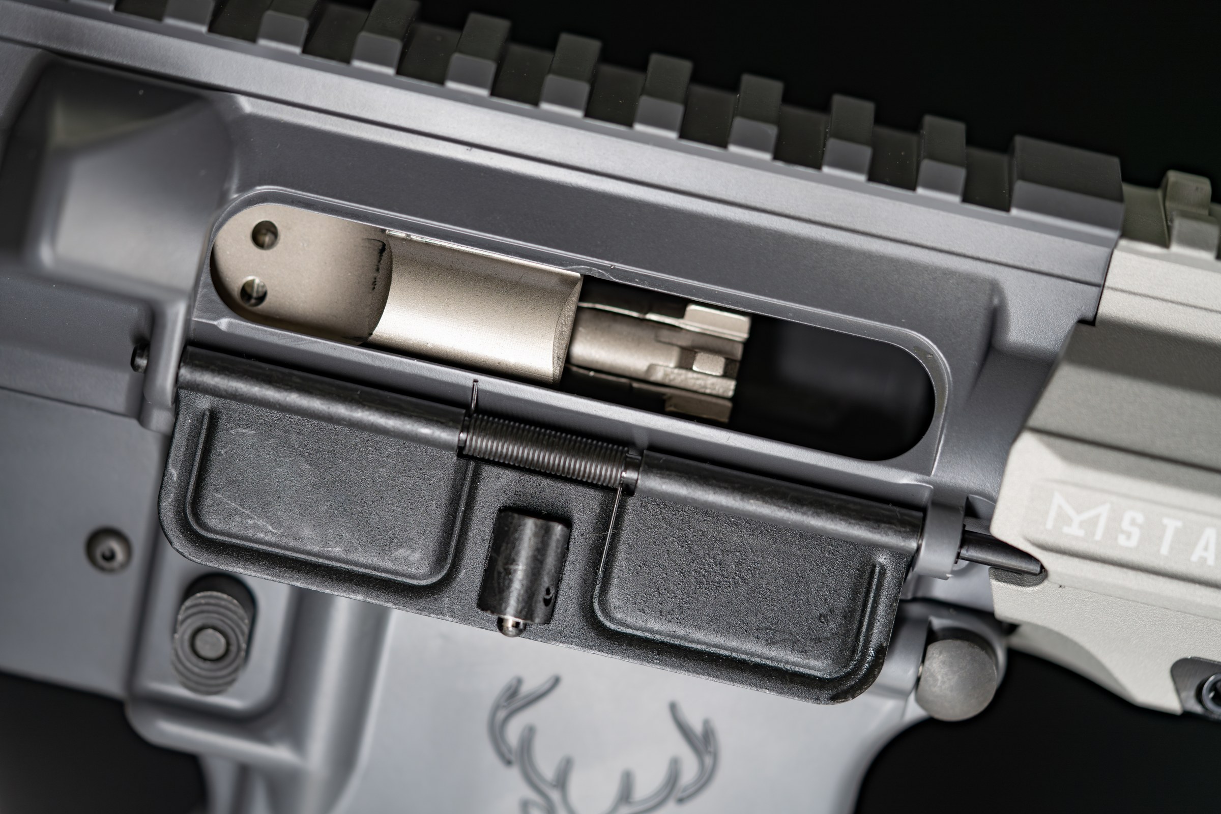 Figure 9 — The carrier in the receiver from the other side. The gas rings and the bolt tail live inside this assembly, and Volume 7 §7.2 explains why they are the parts that decide whether a suppressed subson…
