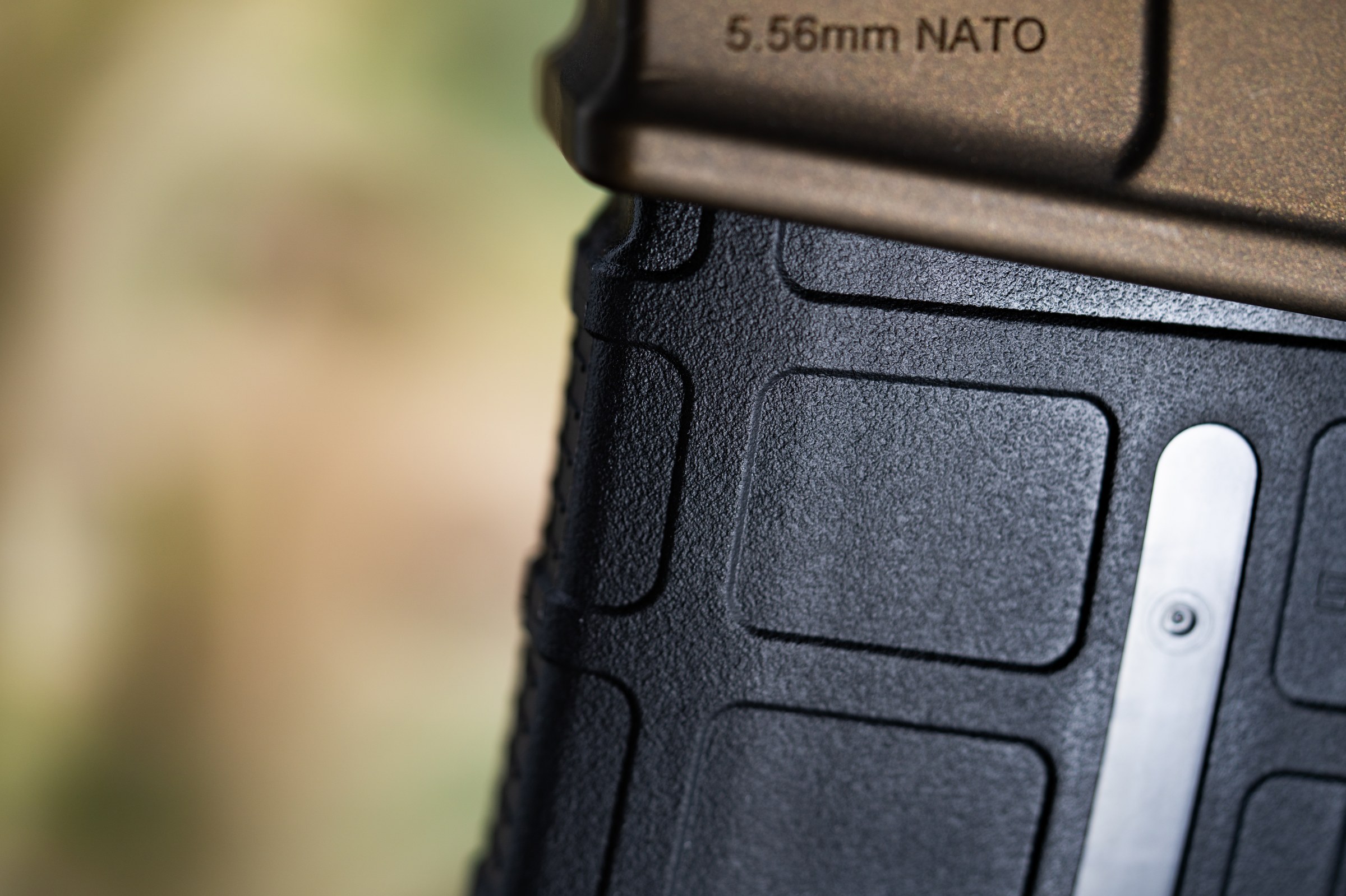 Figure 11 — An AR-15 magazine, marked 5.56mm NATO. The magazine marking is the only cartridge information present anywhere in the reloading sequence — and a .300 Blackout round will feed from this magazine, in…