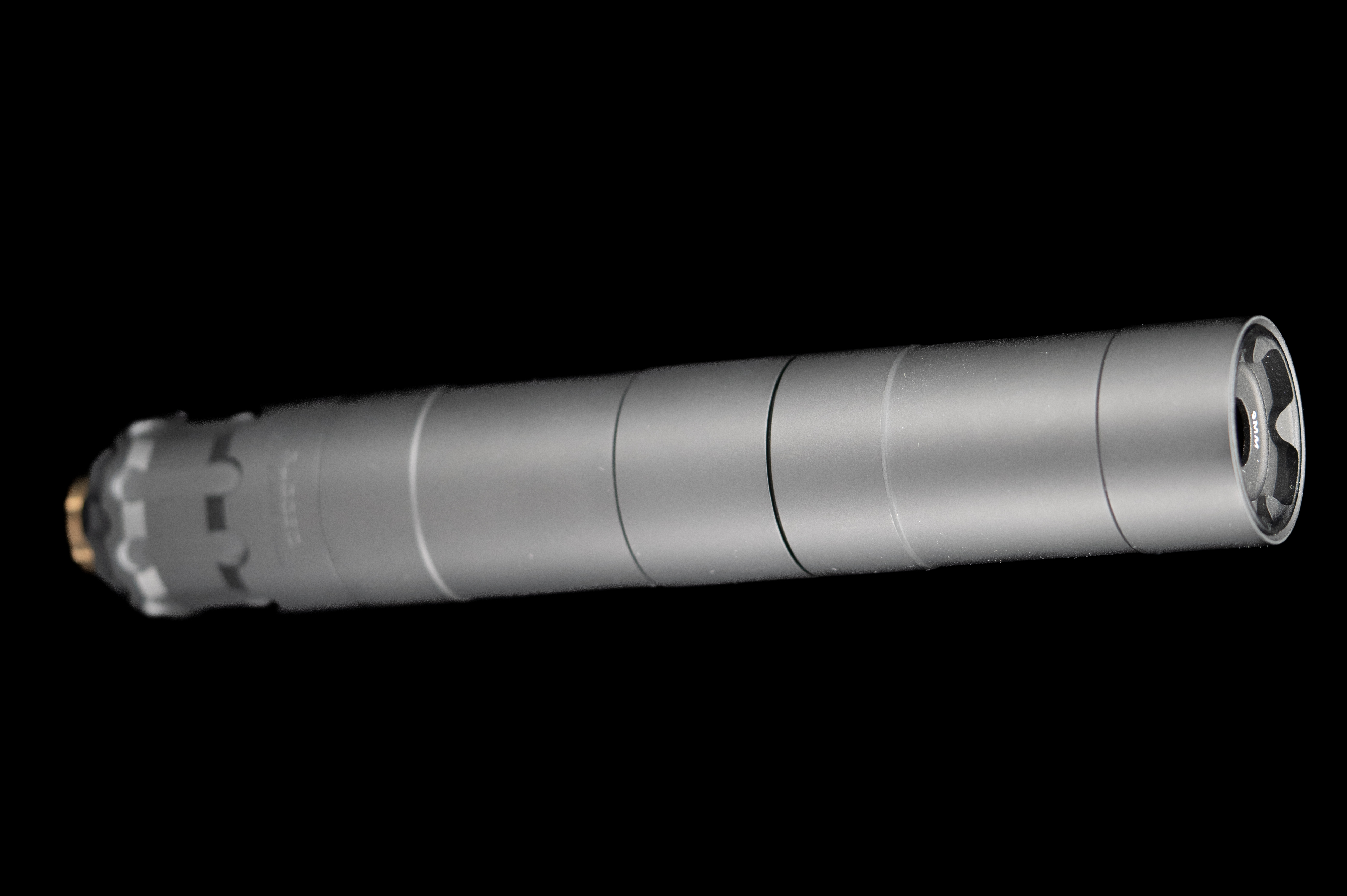 Figure 2 — A modern rifle suppressor. What matters on an 8-inch .300 Blackout host is less the decibel figure than the rating: a short barrel is a far harsher thermal environment than the 16-inch barrel most …