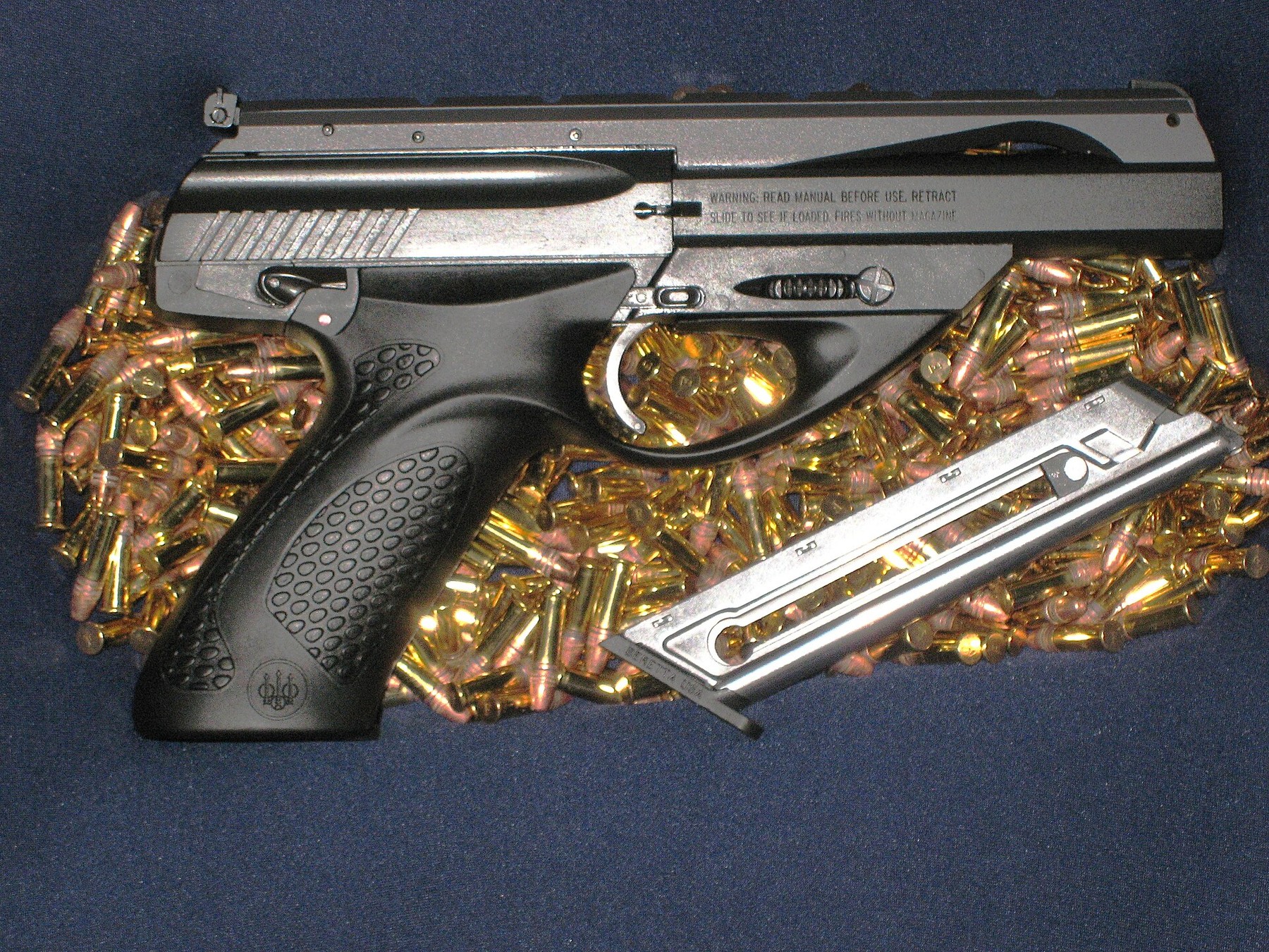 Figure 4 — A U22 Neos, right side. The receiver's right flank carries Beretta's warning legend in two lines — read the manual, retract the slide to see if loaded, fires without magazine — which is the pistol …