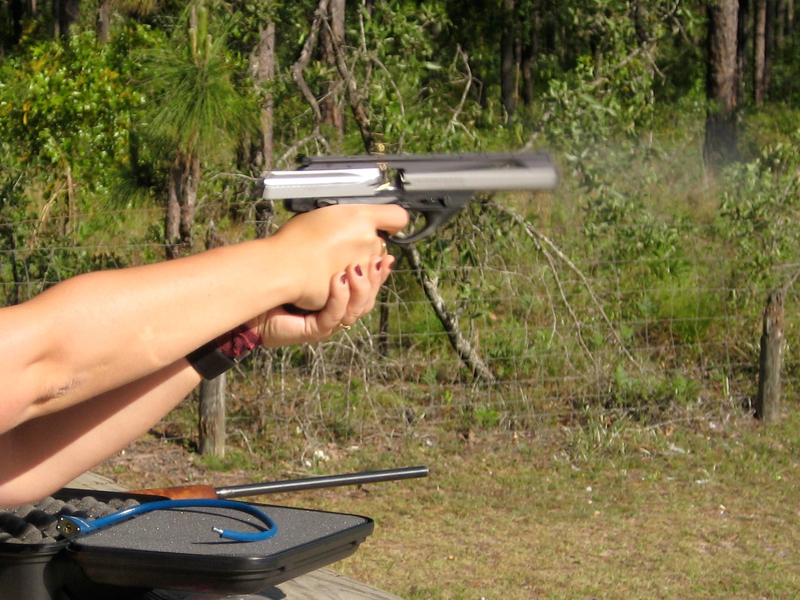 Figure 7 — Firing a 6-inch Inox Neos, with the spent case spinning clear of the ejection port. Photograph by Trevor P. Hirst via Wikimedia Commons, CC BY-SA 3.0.