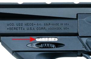 Figure 3 — Beretta's own photograph of the markings, made for the 2010 recall site to show owners where to find the serial number. The model, calibre and maker lines are on the barrel; the arrow points to the…