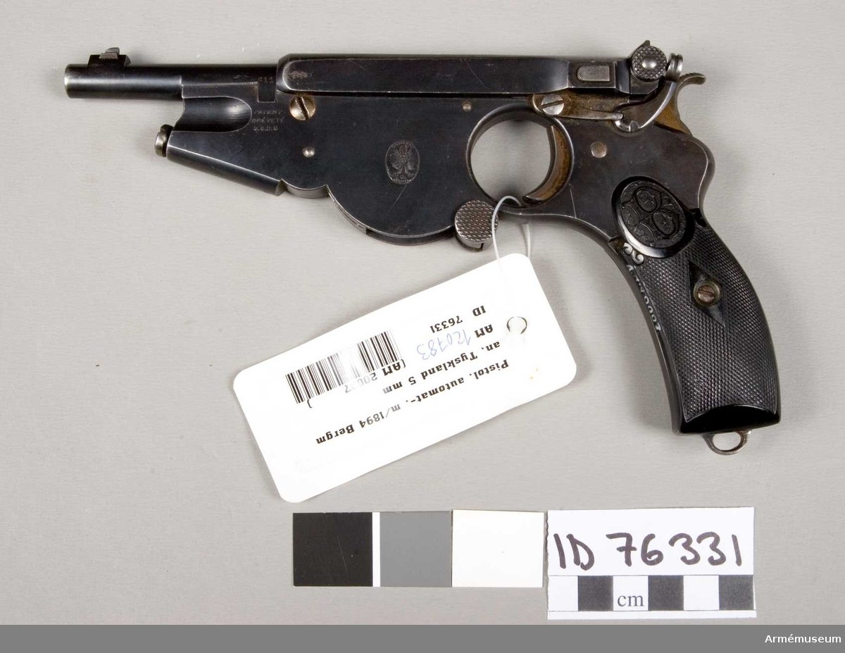 Figure 7 — The Armémuseum's 5 mm Bergmann, ID 76331, catalogued "Pistol m/1894". The ring trigger guard and the plain frame under the barrel make it an 1896-pattern No. 2; 611 on the barrel is the calibre cod…