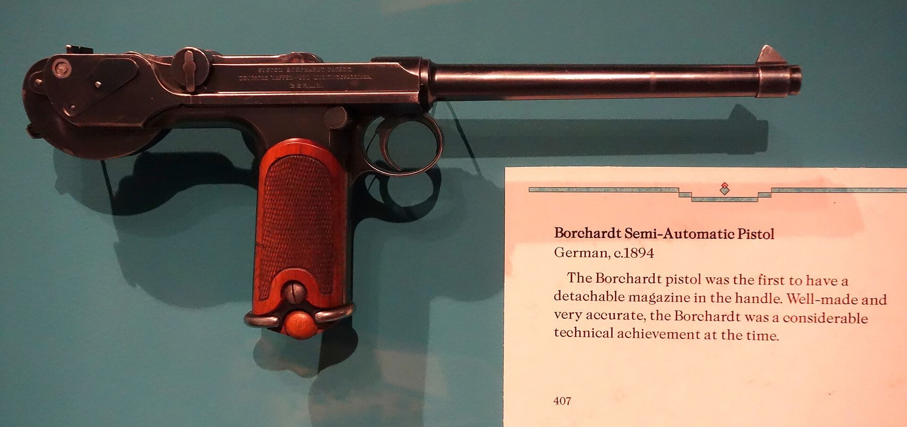 Figure 3 — The Glenbow Museum's C-93, right side. The three-line marking on the receiver names Deutsche Waffen- und Munitionsfabriken, so this is a DWM pistol, made in or after 1897. The museum's label, visib…