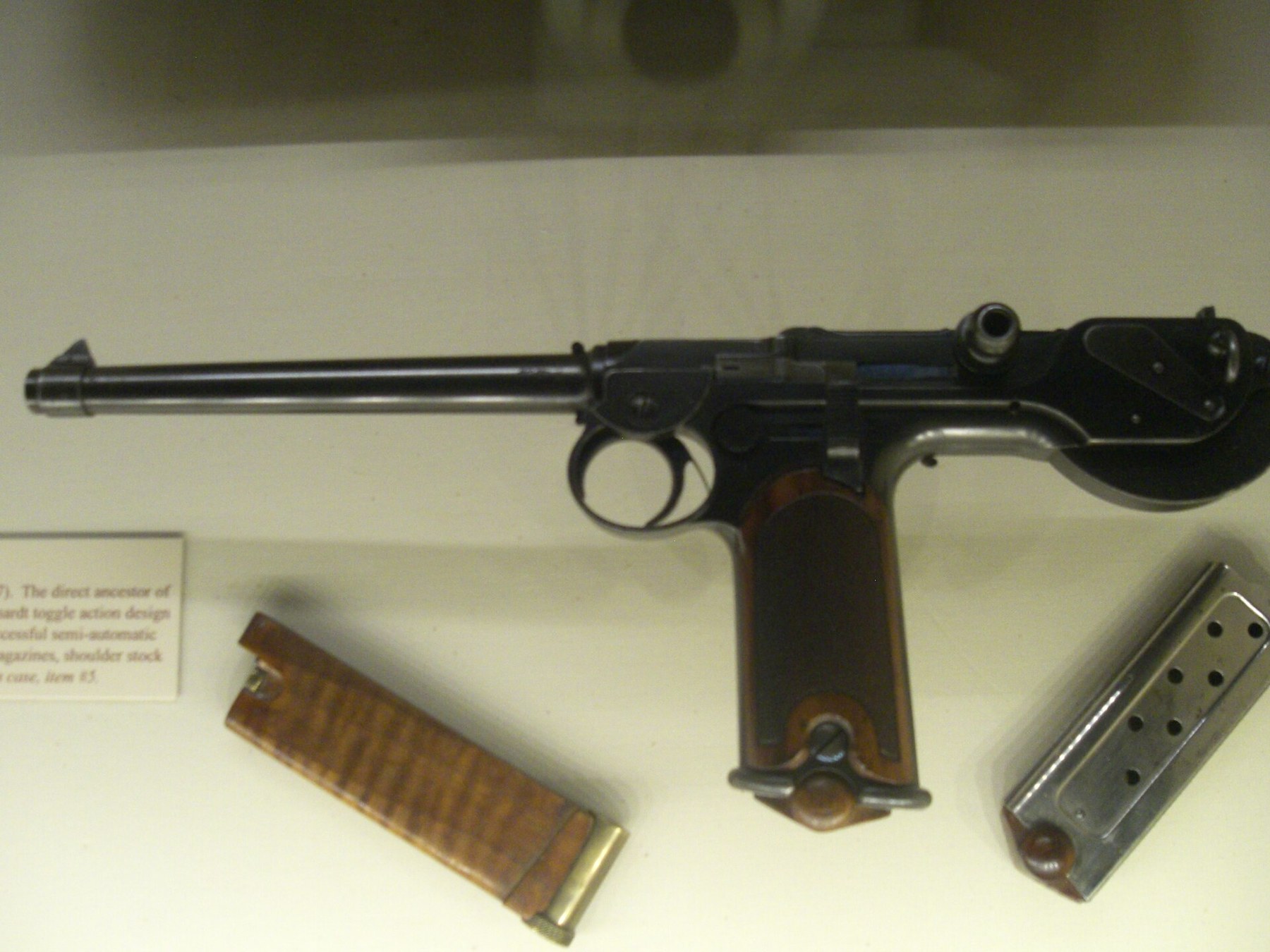 Figure 6 — The same museum's C-93 in an earlier photograph, with the spare magazine and the wooden barring block lying below it. The magazine's wooden base and witness holes are visible.