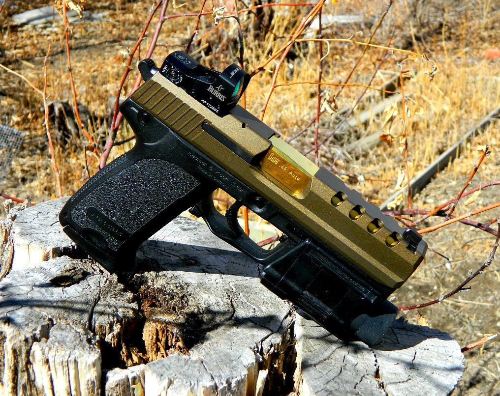 Figure 4 — A customised USP45 with a ported, two-tone slide and a red-dot sight, credited in the file's title to a custom builder. It shows the kind of slide work owners commission on H&K .45s; nothing like i…