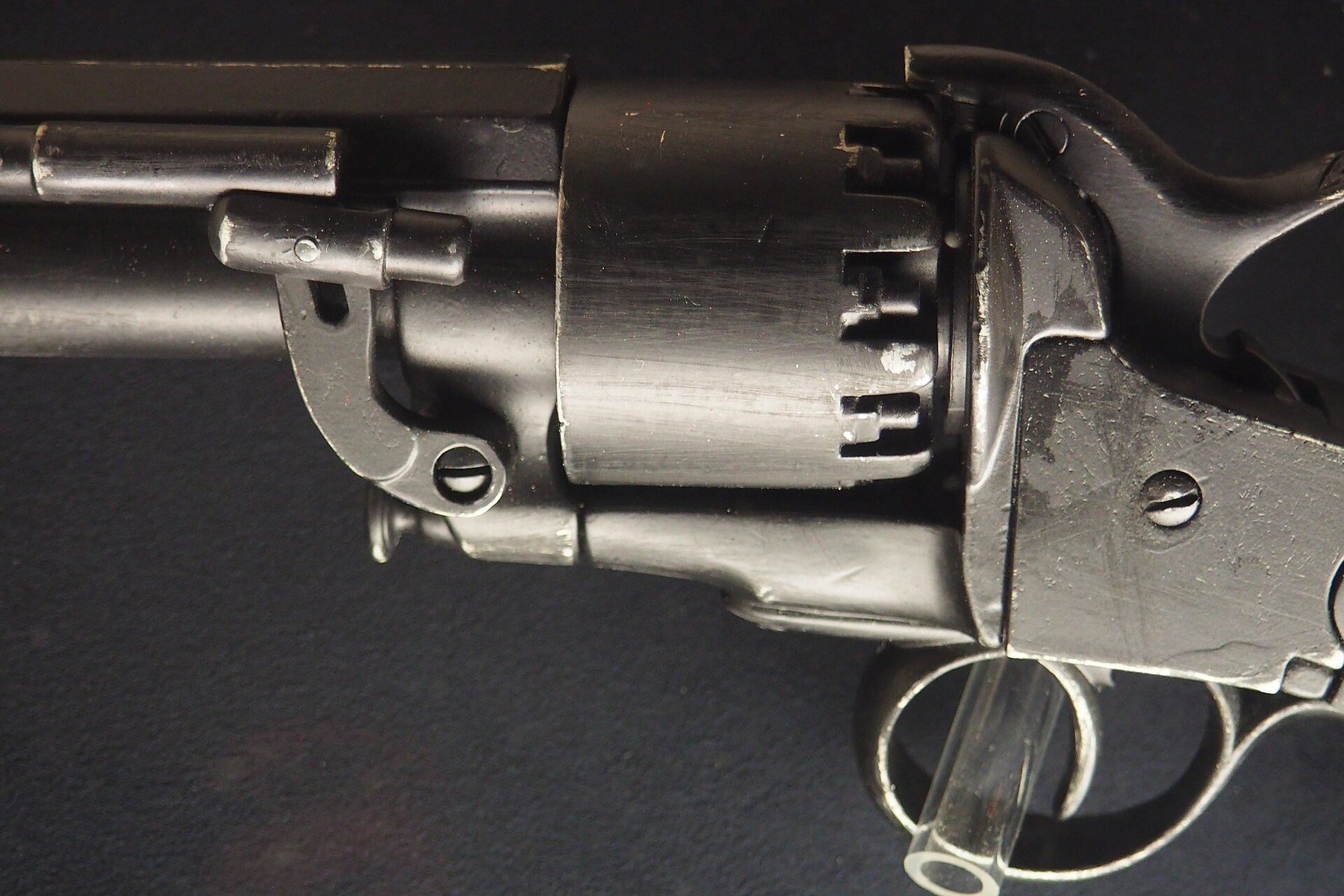 Figure 3 — A non-firing Denix replica photographed close to the frame and cylinder, showing the arrangement every LeMat shares: the shot barrel emerging from the centre of the cylinder, the rifled barrel's lu…