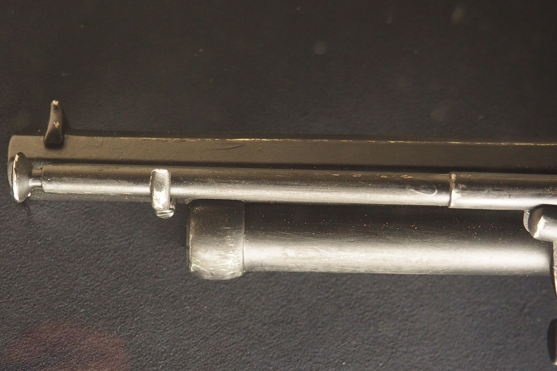 Figure 7 — The loading lever of a Denix replica, under the rifled barrel, with the shot barrel below it. On the originals the lever's handle is hollow and carries the short rammer for the shot barrel; that ho…