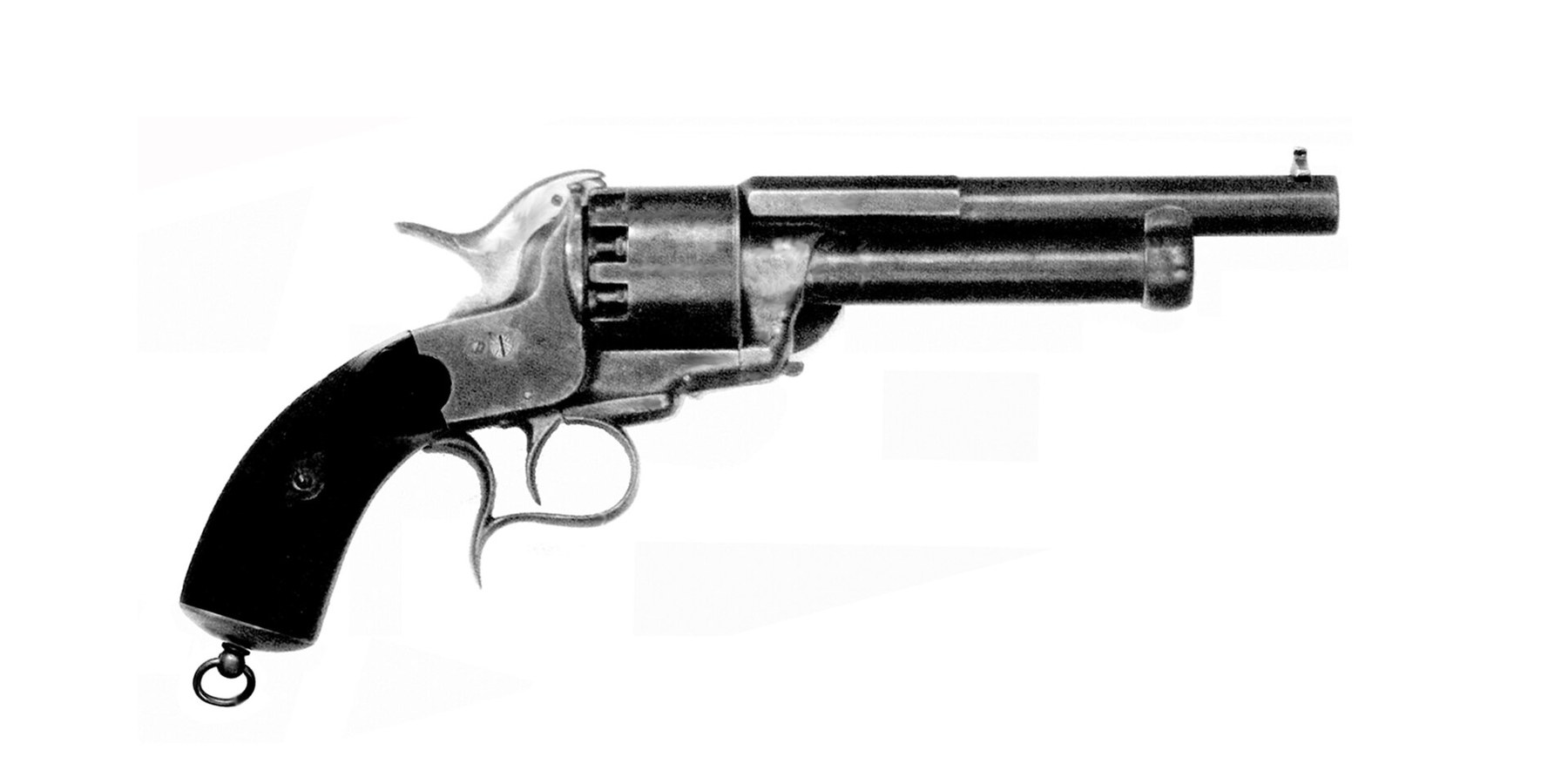 Figure 2 — A LeMat photographed from the left side, with the First Model's spurred trigger guard and a swivelling lanyard ring through the butt; no loading lever shows on this side because the First Model's l…