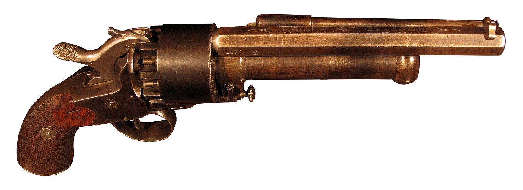 Figure 1 — A LeMat revolver in the Musée de l'Armée, Paris, photographed from the right side. The octagonal rifled barrel carries an engraved address in Gothic letters between scrolled borders; beneath it the…