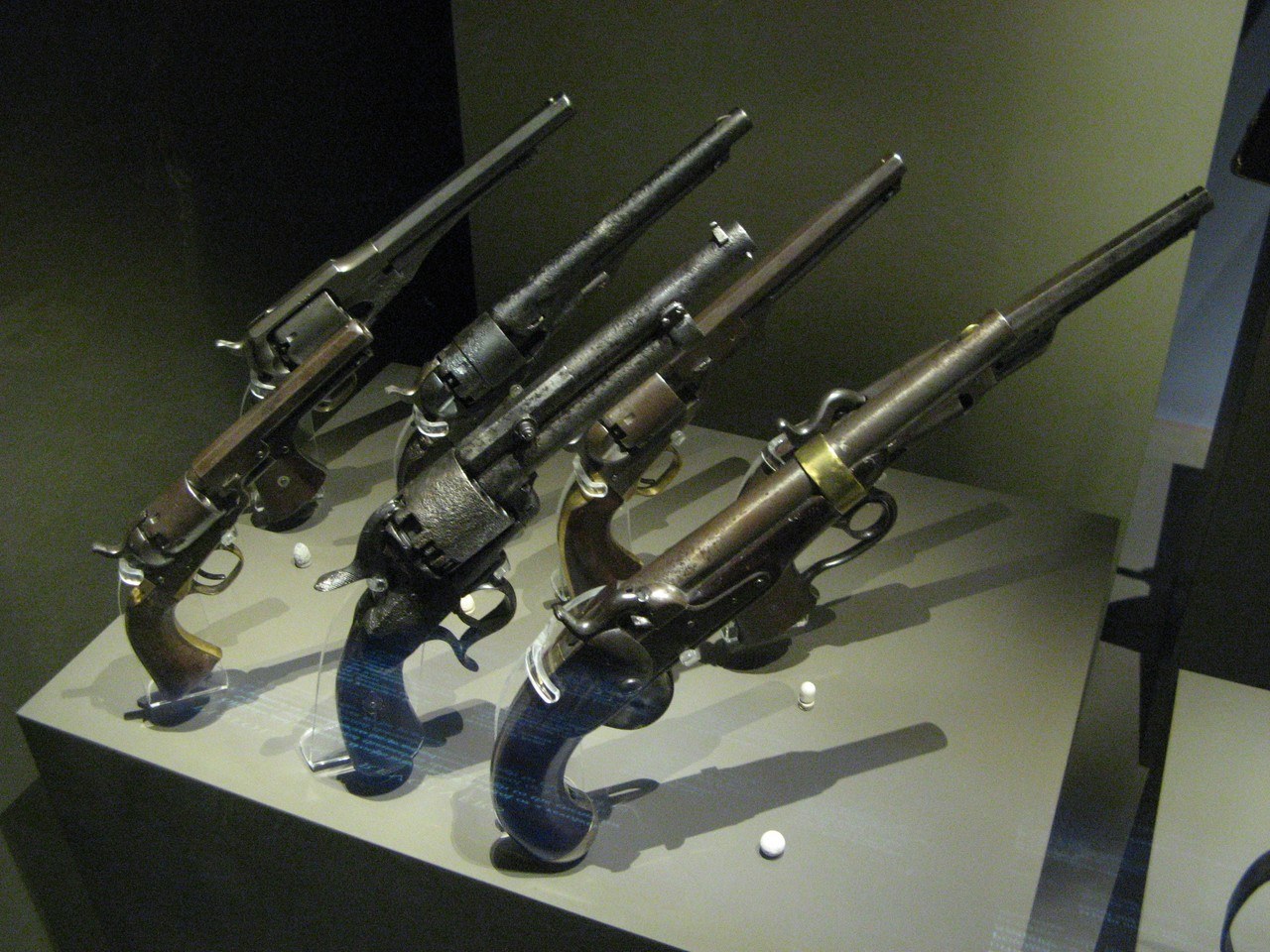 Figure 3 — A display of percussion revolvers at the Henry Hill Visitor Center, Manassas National Battlefield Park. The heavily corroded revolver with the large cylinder at the centre of the front row appears …