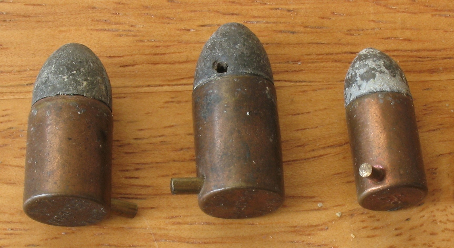 Figure 7 — Pinfire cartridges. The pin projecting from the side of the case rests on a priming cap inside; the hammer drives it in. LeMat's pinfire revolvers fired the 12 mm Lefaucheux cartridge from the cyli…