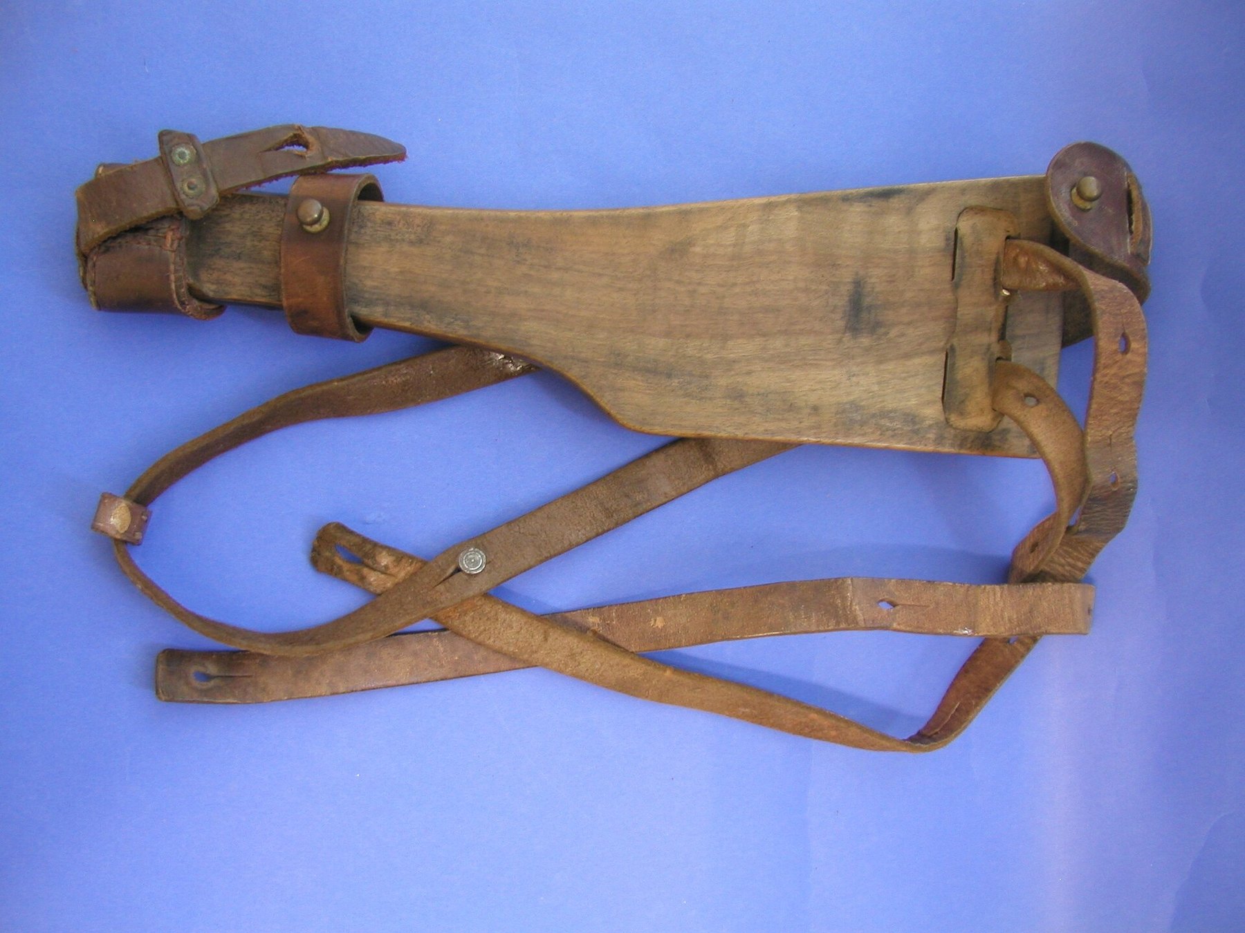 Figure 2 — A long pistol's board stock with its leather holster attached, the arrangement ATF's list calls an "artillery-type, detachable wooden shoulder stock": the same DWM 1917 pistol's stock in the Auckla…