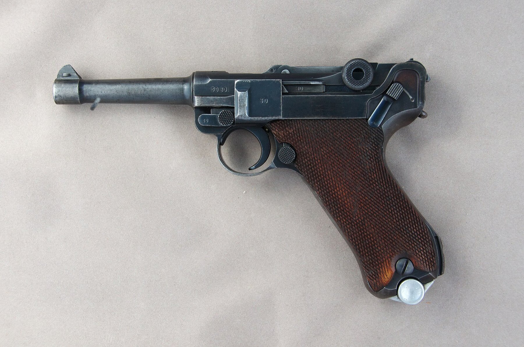 Figure 1 — A Mauser-made Luger of 1938, left side, with the S/42 code that hid the maker's name on the front toggle link. The studio photograph is one of a pair; the other side appears in Volume 5.