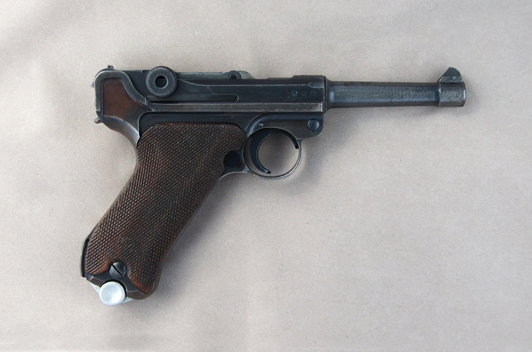 Figure 3 — The right side of the 1938 Mauser pistol in the plate at the head of this volume: the side plate with its takedown lever at the front of the frame, and the serial number and proof marks on the rece…