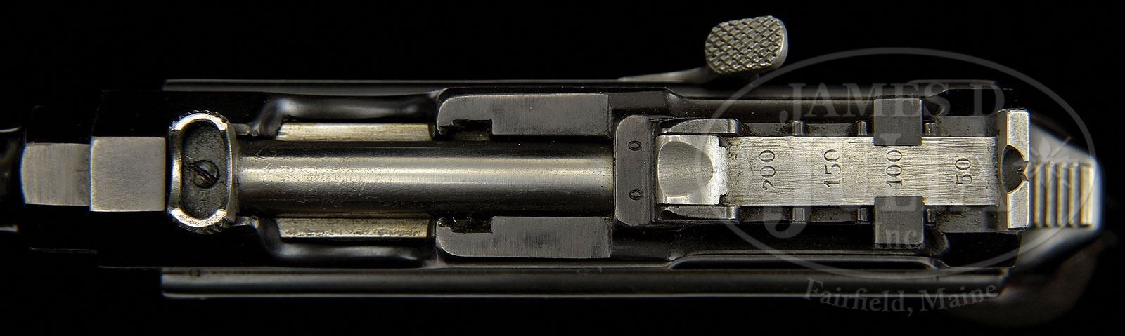 Figure 9 — The same pistol from above with the bolt drawn back: the open receiver, the bolt's knurled grip and the clip guide. Photograph: James D. Julia, October 2013, lot 3192.
