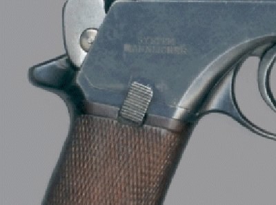 Figure 5 — The serrated magazine-unloading lever at the top of the right grip panel of an M1901. Photograph: Wesley Terrell, CC BY-SA 3.0, via Wikimedia Commons.