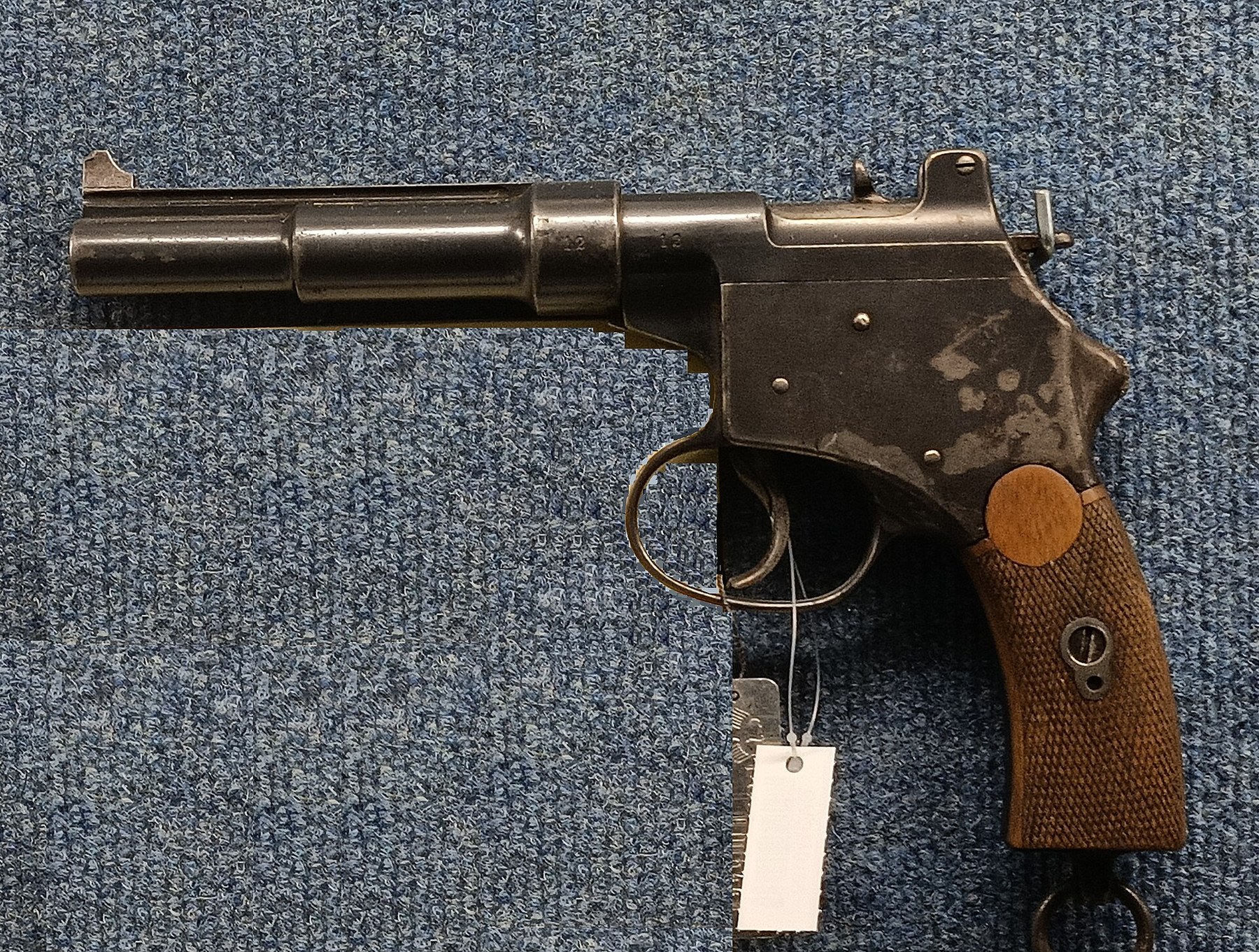 Figure 1 — A Mannlicher M1894 blow-forward pistol in the Wehrtechnische Studiensammlung Koblenz, the German armed forces' study collection. The barrel and its casing run forward from the frame; the hammer and…