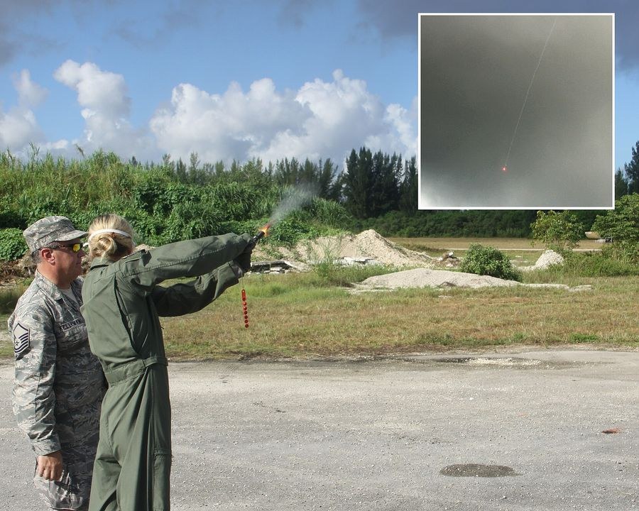 Figure 2 — A U.S. Air Force pilot fires a gyrojet flare gun during combat survival training at Homestead Air Reserve Base, Florida, in September 2010, watched by her instructor; the inset shows the flare fall…