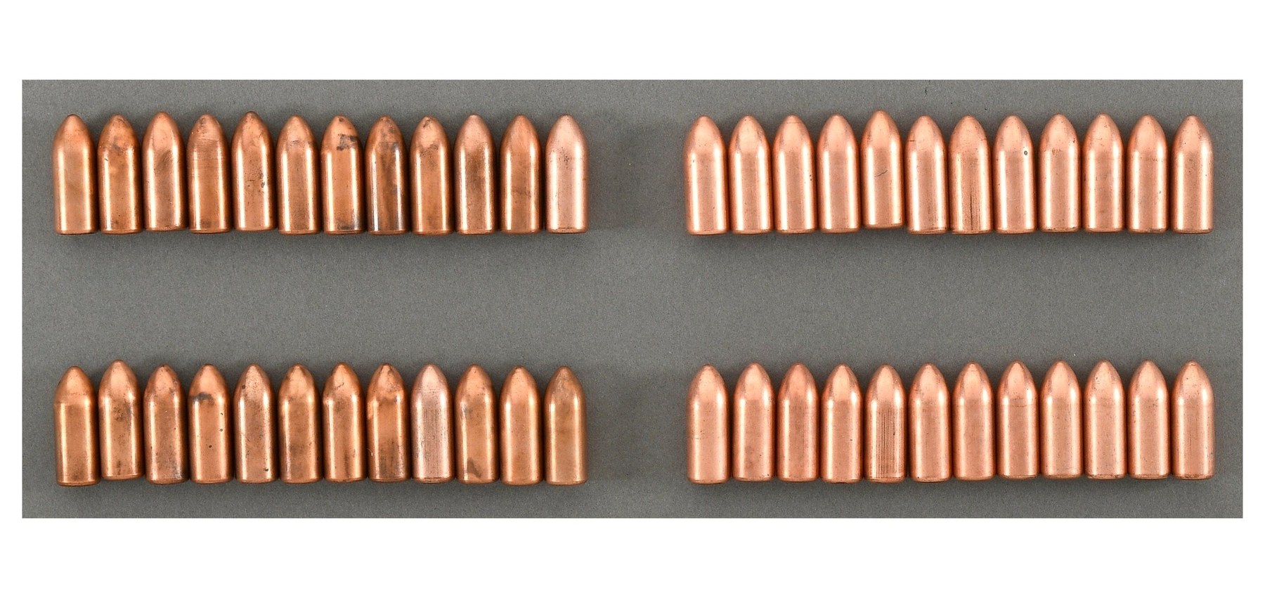 Figure 3 — A lot of forty-eight 13 mm Gyrojet rounds, laid out in four rows. Consigned by the descendant of a man who "worked for MBA in the late 60s and early 70s in California", it sold at Rock Island on 5 …