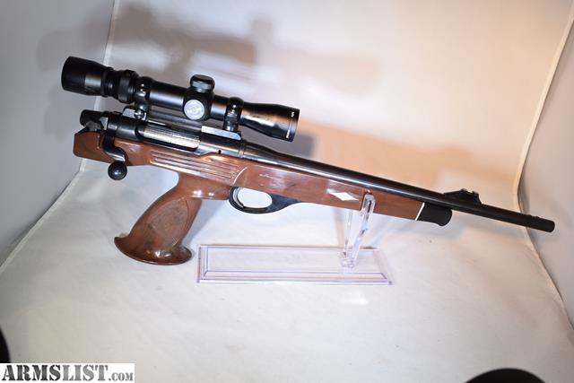 Figure 4 — A centre-grip XP-100 presented for sale on a stand. A photograph at this angle shows the grip position, the stock pattern and the scope base, which is three of the six identification checks above —…