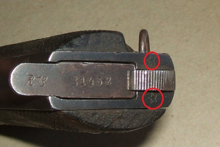Figure 4 — The base of a French-service Ruby-type, from Forgotten Weapons: a star stamped on each side of the heel magazine catch (circled by Forgotten Weapons), and a magazine base stamped with the maker's l…