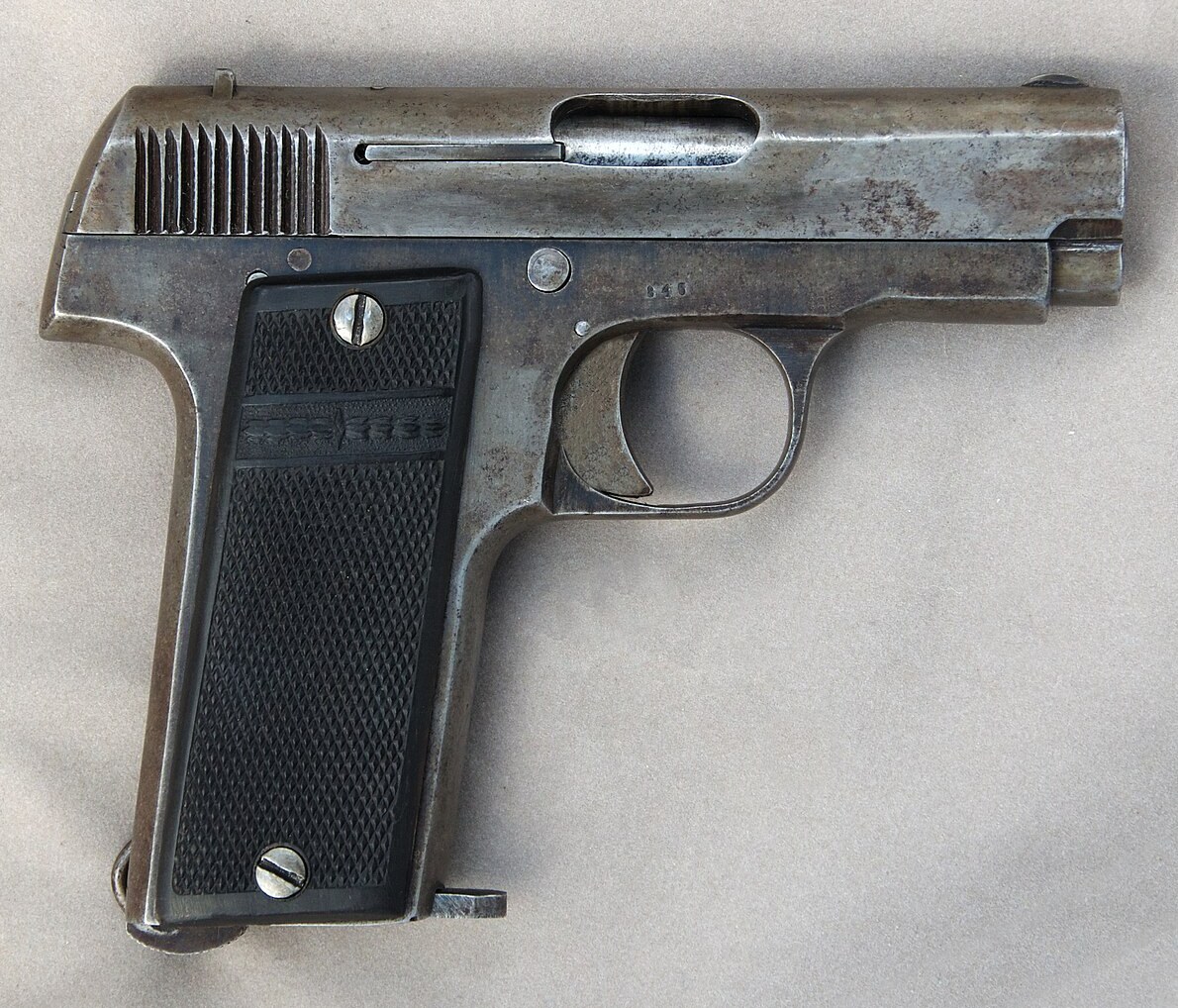 Figure 4 — The right side of the 1920s Vilar, with moulded grip panels crossed by a decorated band; compare the left side in Vol 3, whose oval reads MADE IN SPAIN. Photograph by Self Loader, CC0, via Wikimedi…