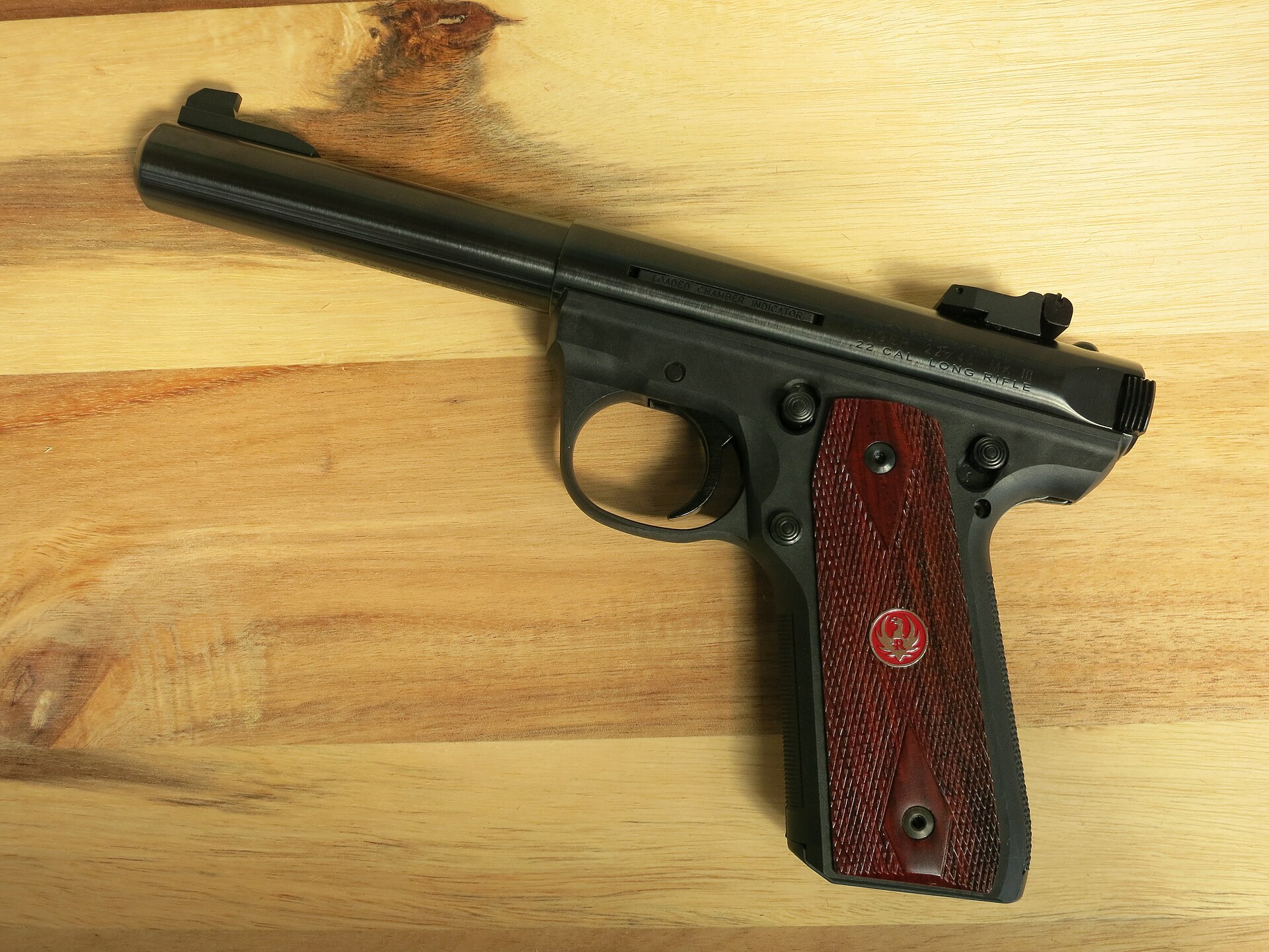 Figure 2 — A blued 22/45 Mark III with rosewood-pattern grip panels. The 22/45's polymer frame has the steeper grip angle of the Colt 1911, and its magazine has a longer base to match. Ruger's manuals state a…