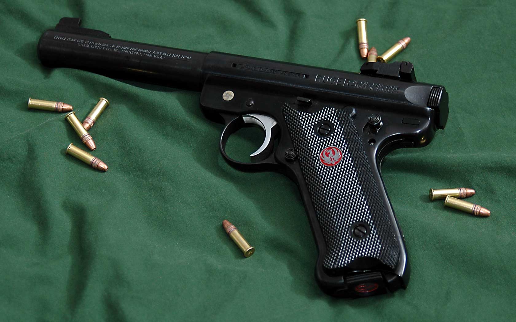Figure 7 — A blued Mark III with a bull barrel and adjustable rear sight — the configuration Ruger catalogued as the Mark III Target. Three Mark III details are visible on the left side: the roll mark reading…