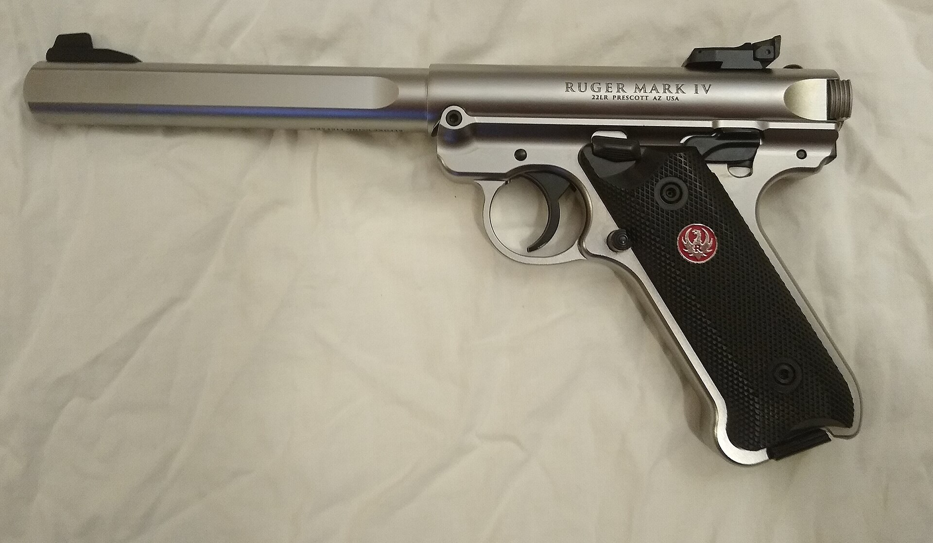 Figure 10 — A stainless Mark IV Competition fitted with standard grips. The Mark IV's identifying details are at the rear of the frame: the ambidextrous safety lever above the grip panel, and the takedown butt…