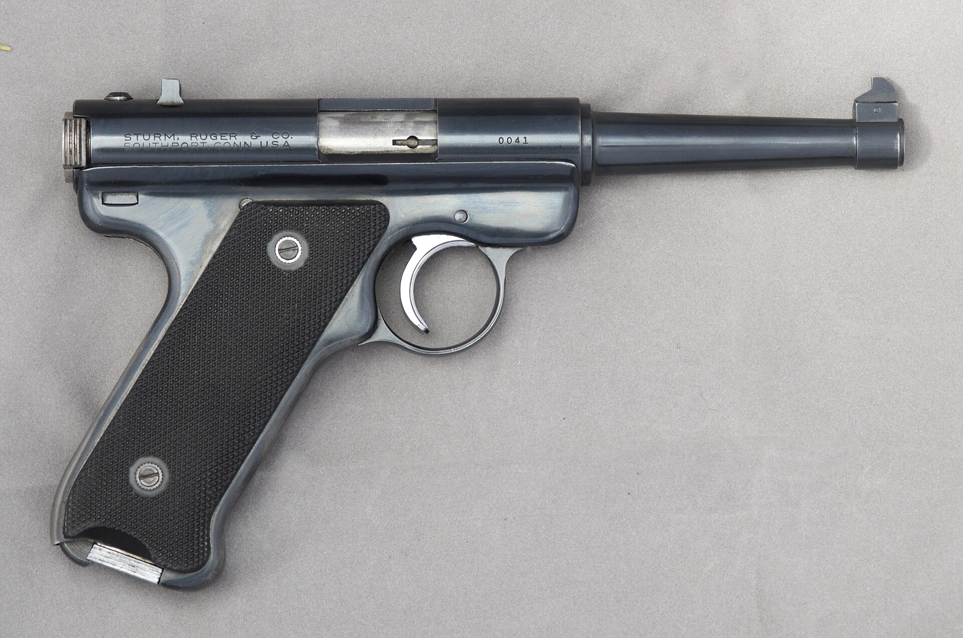 Figure 7 — The same serial-41 Standard from the right side: the Ruger roll-mark and address on the receiver, and the red-centred medallion in the grip panel. The magazine catch is the lever at the very bottom…