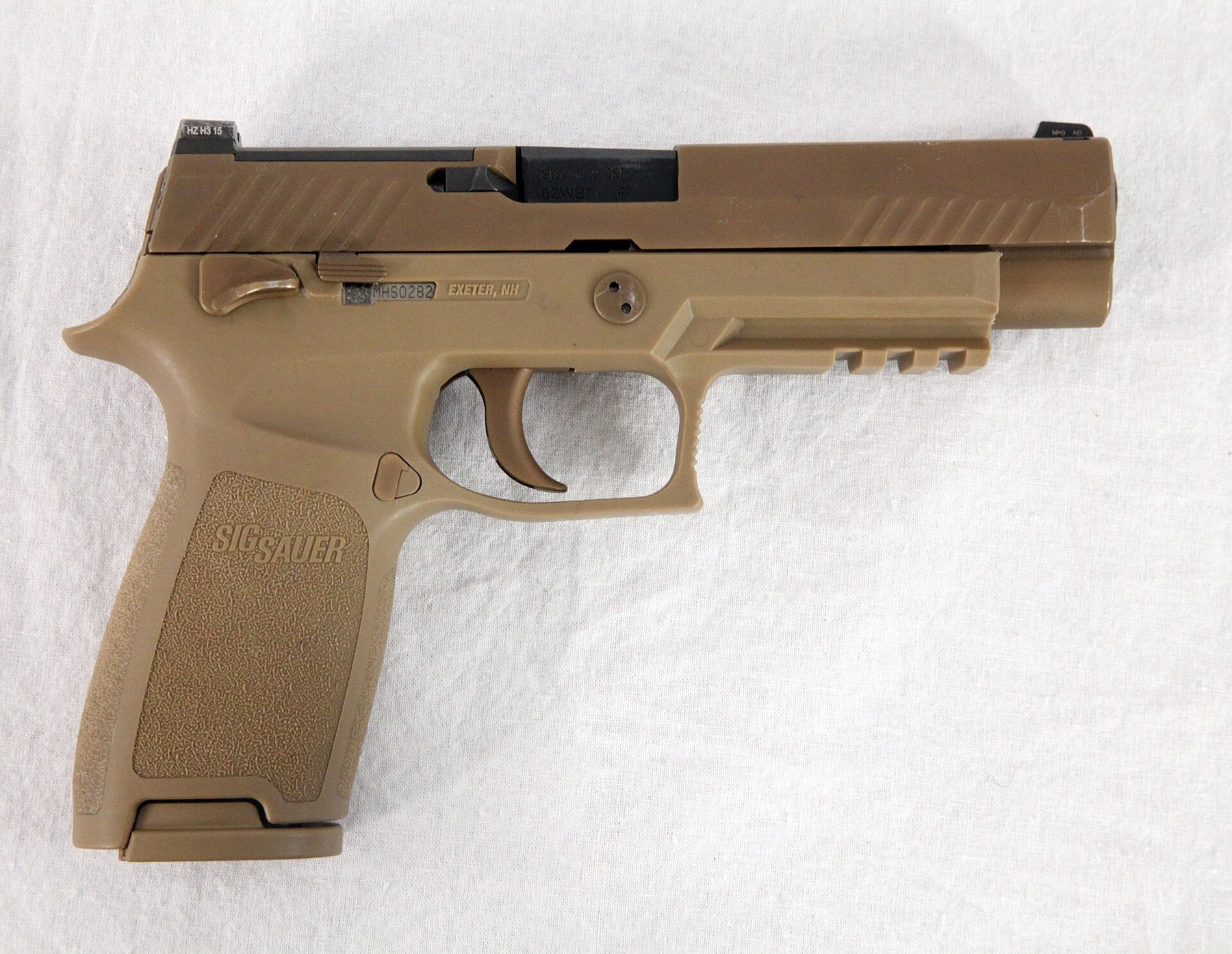Figure 1 — The XM17, the full-size Modular Handgun System pistol, as photographed by the Army. The thumb safety sits above the trigger; the serial number of the fire control unit shows through a window in the…