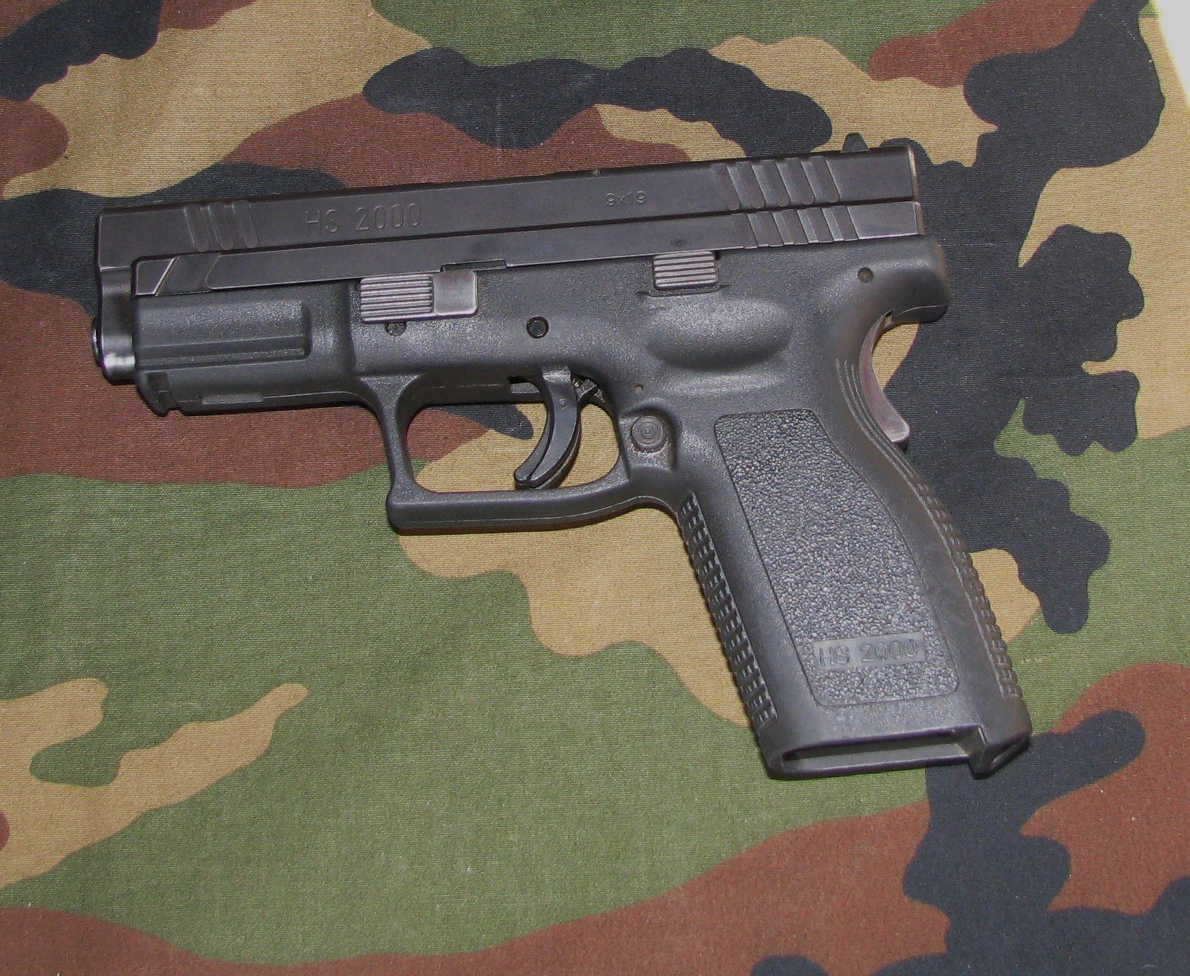 Figure 2 — An HS2000 in 9×19 mm, the Croatian pistol from which the XD family descends. The slide is marked "HS 2000" and "9x19". The external layout is the XD's almost exactly: the grip safety in the backstr…