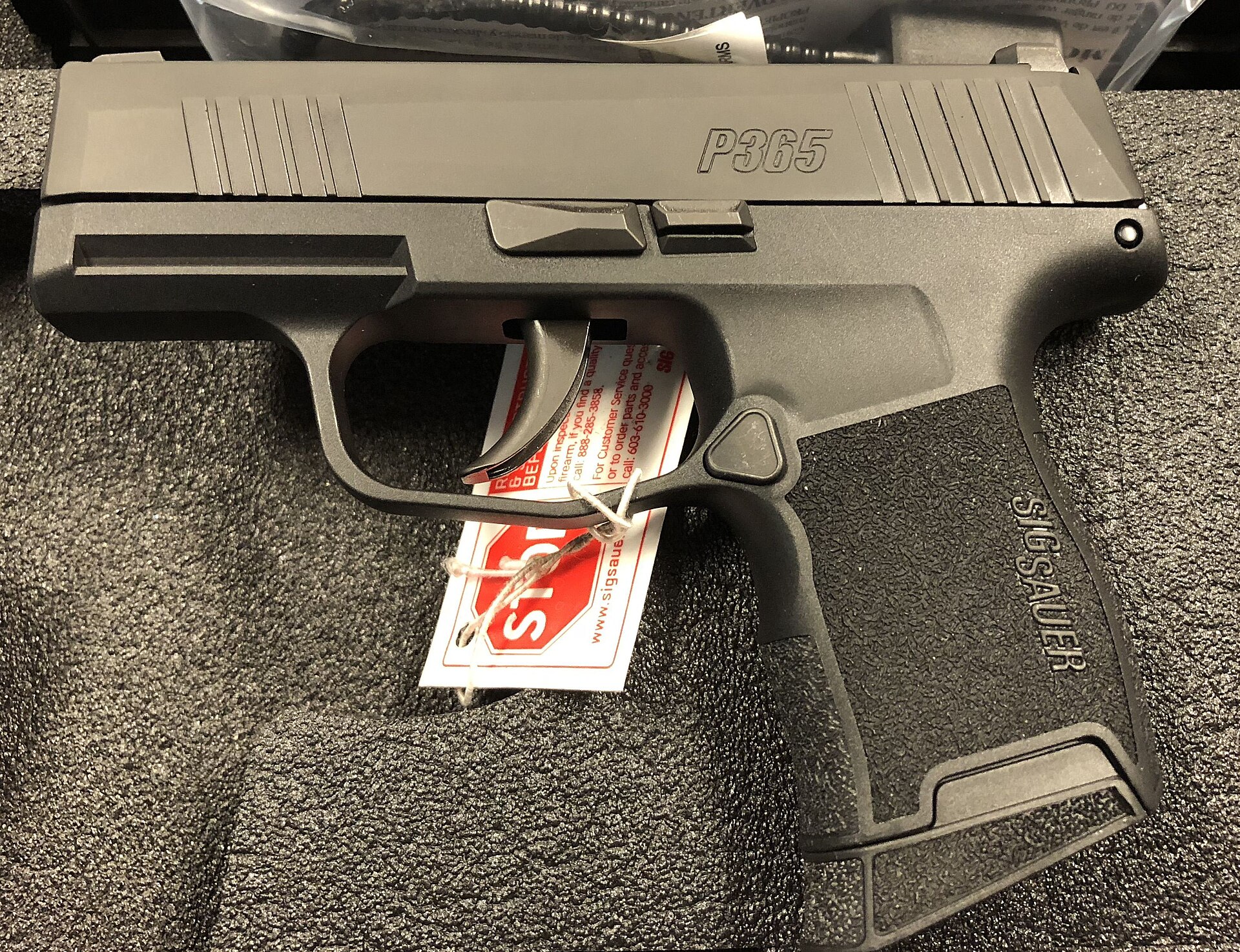 Figure 5 — A SIG Sauer P365. A staggered magazine that tapers to a single-column feed at the top let the grip stay close to single-stack width while holding ten rounds flush — three more than an original Shield.