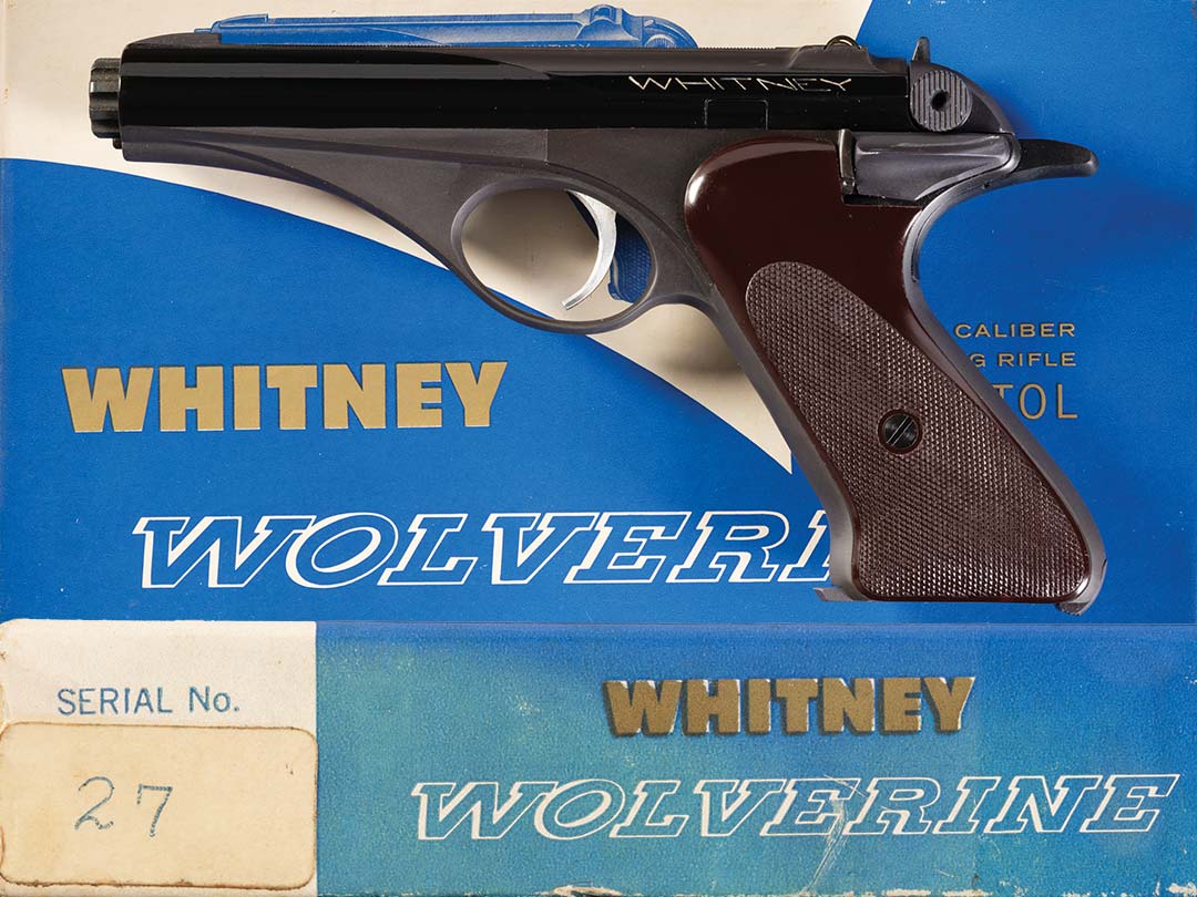 Figure 1 — A presentation-series Whitney, serial 27, with its box; the end label reads "Serial No. 27" in hand. Rock Island Auction describes it as one of 28 pistols built on frames numbered "1" to "37" and r…
