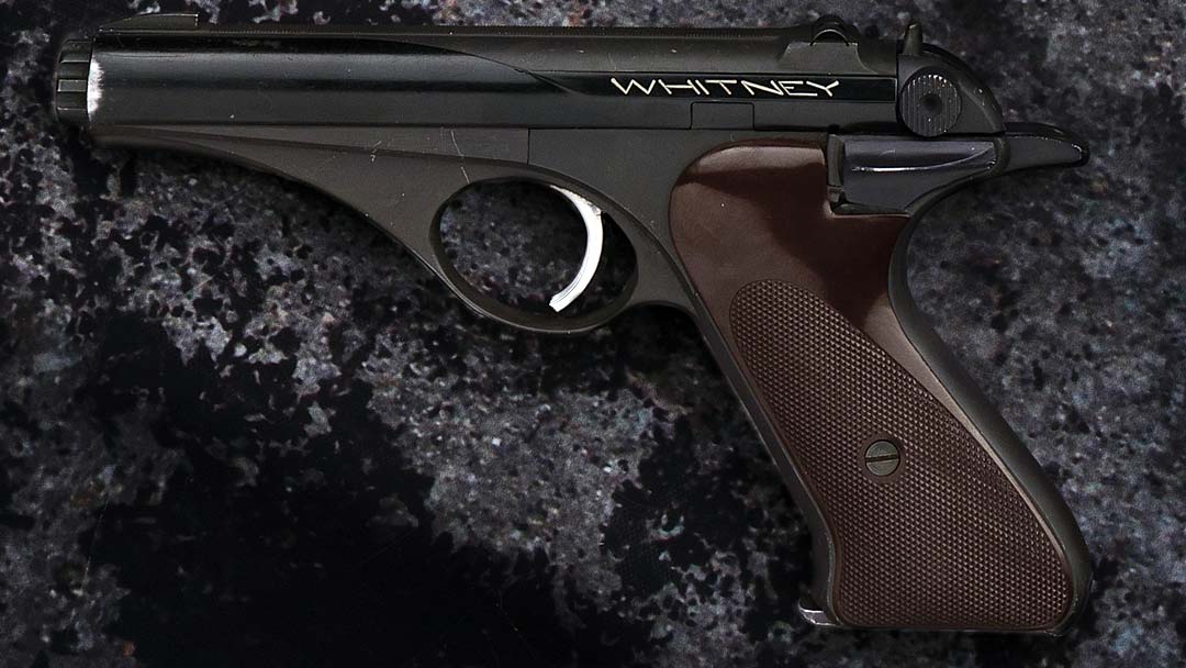 Figure 3 — A Whitney in the standard black finish, in profile. Read from the left: cocking knobs on the end of the internal sleeve; the shrouded hammer; the long spur that "lies over the back of the hand like…