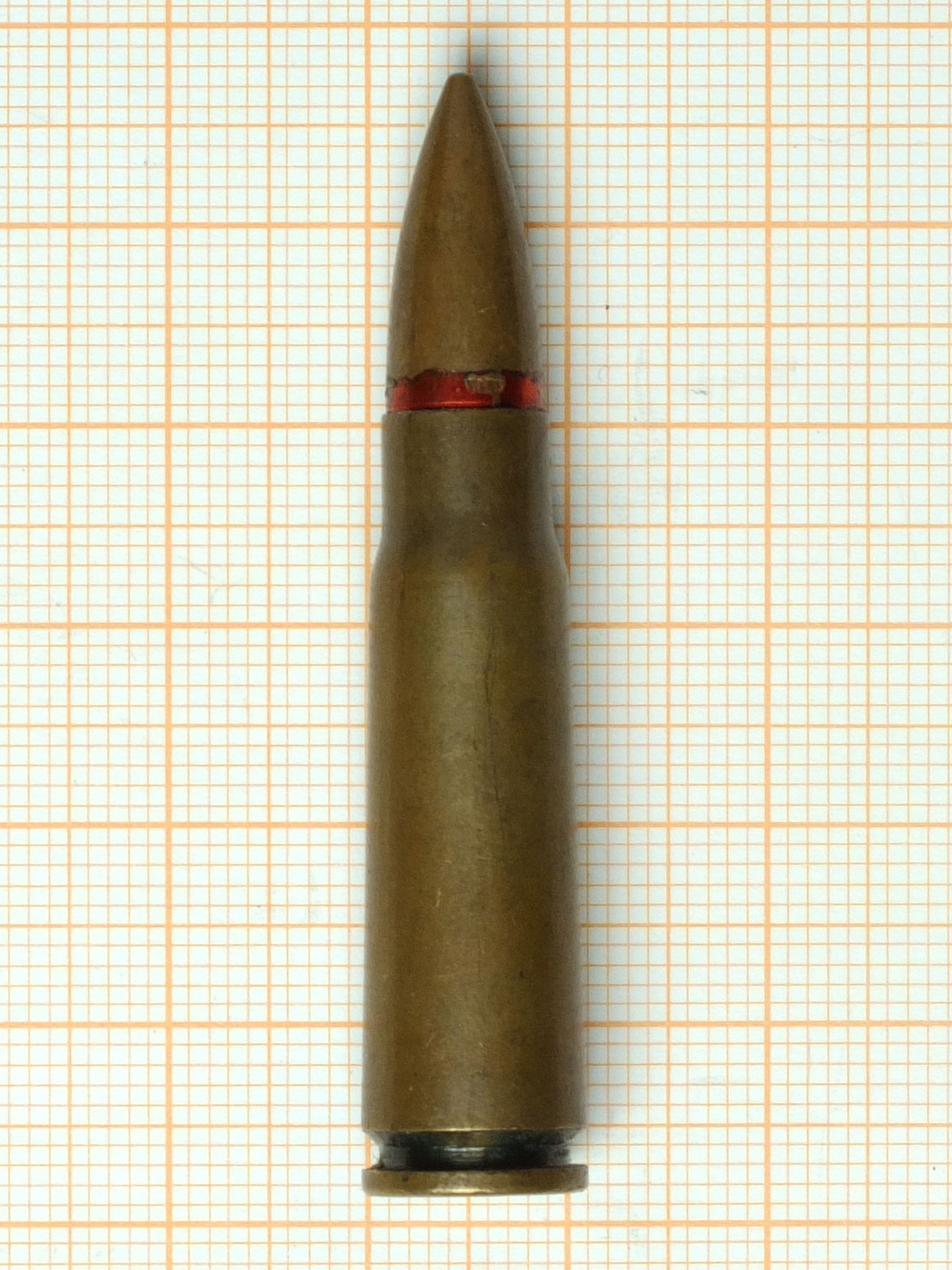 Figure 5 — The same cartridge with a lacquered steel case, photographed at the same scale as the brass-cased round at the head of this volume. The case material is the only difference between them that a rifl…