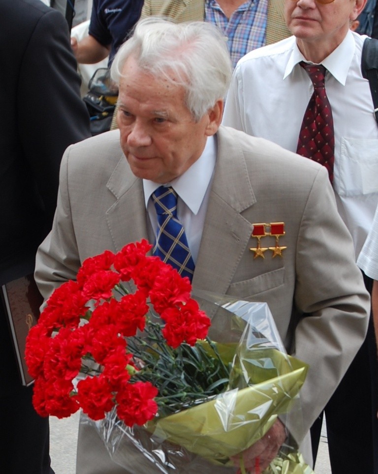 Figure 3 — Mikhail Timofeyevich Kalashnikov in later life. He spent decades as the public face of a design that a state publicity apparatus had every reason to attribute to one man, and spent a good deal of t…