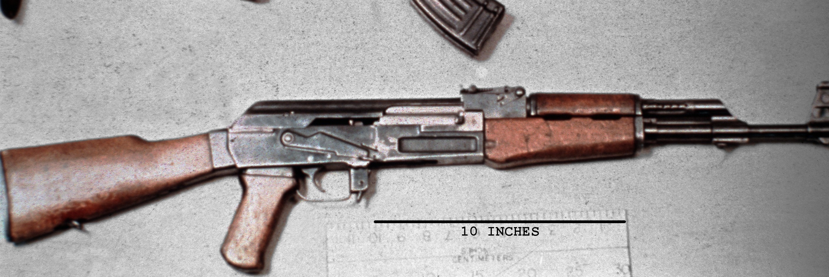 Figure 2 — A milled-receiver AK-47 with a scale. The receiver is a machined block: no rivets in the walls, and a lightening cut along the side. Which way that cut is angled separates the Type 2 from the far m…