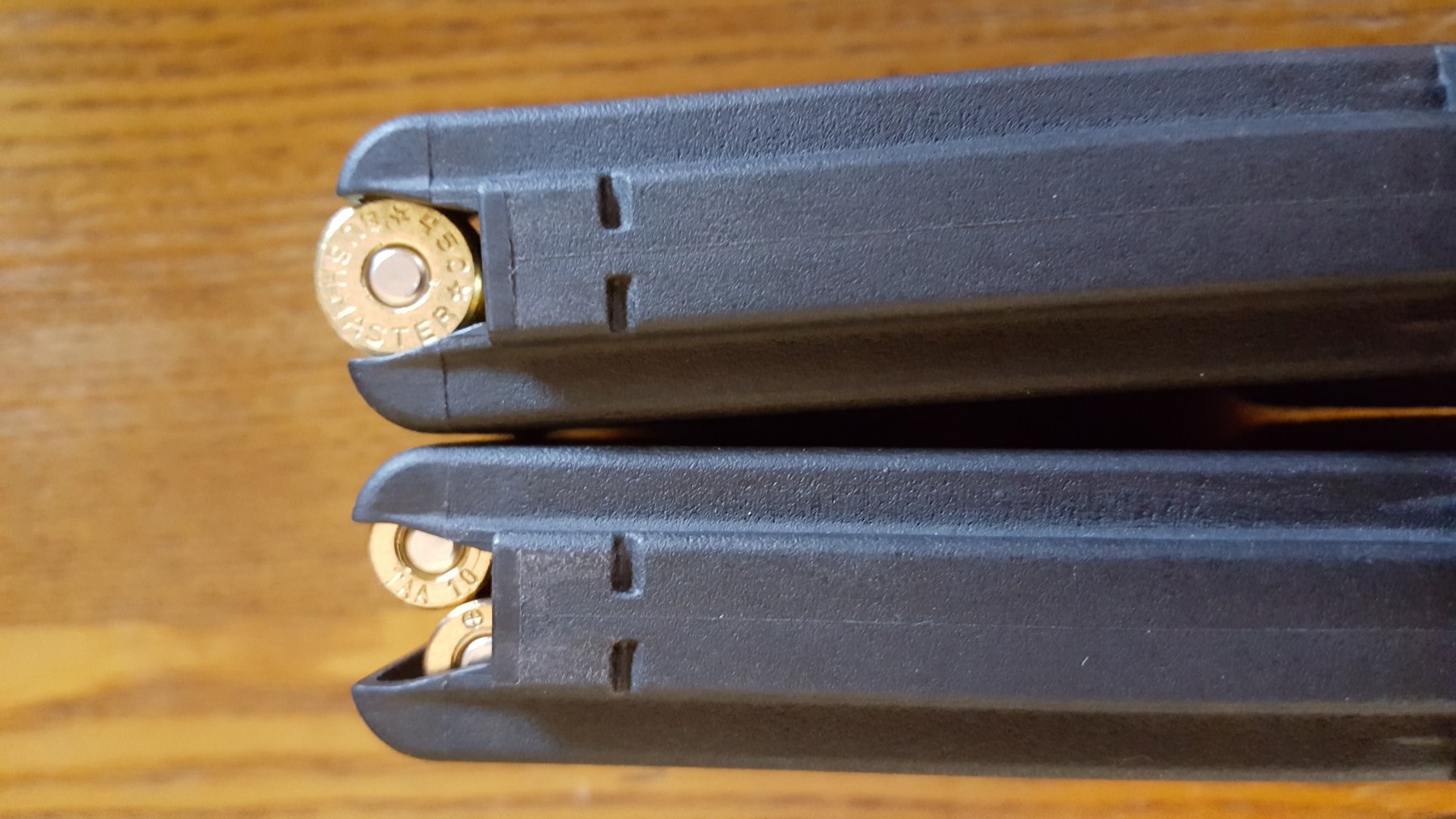 Figure 3 — The two magazines from the rear, showing the feed lips. The .450's single column presents one round at a time from the centre; the 5.56's staggered column presents them alternately from either side…